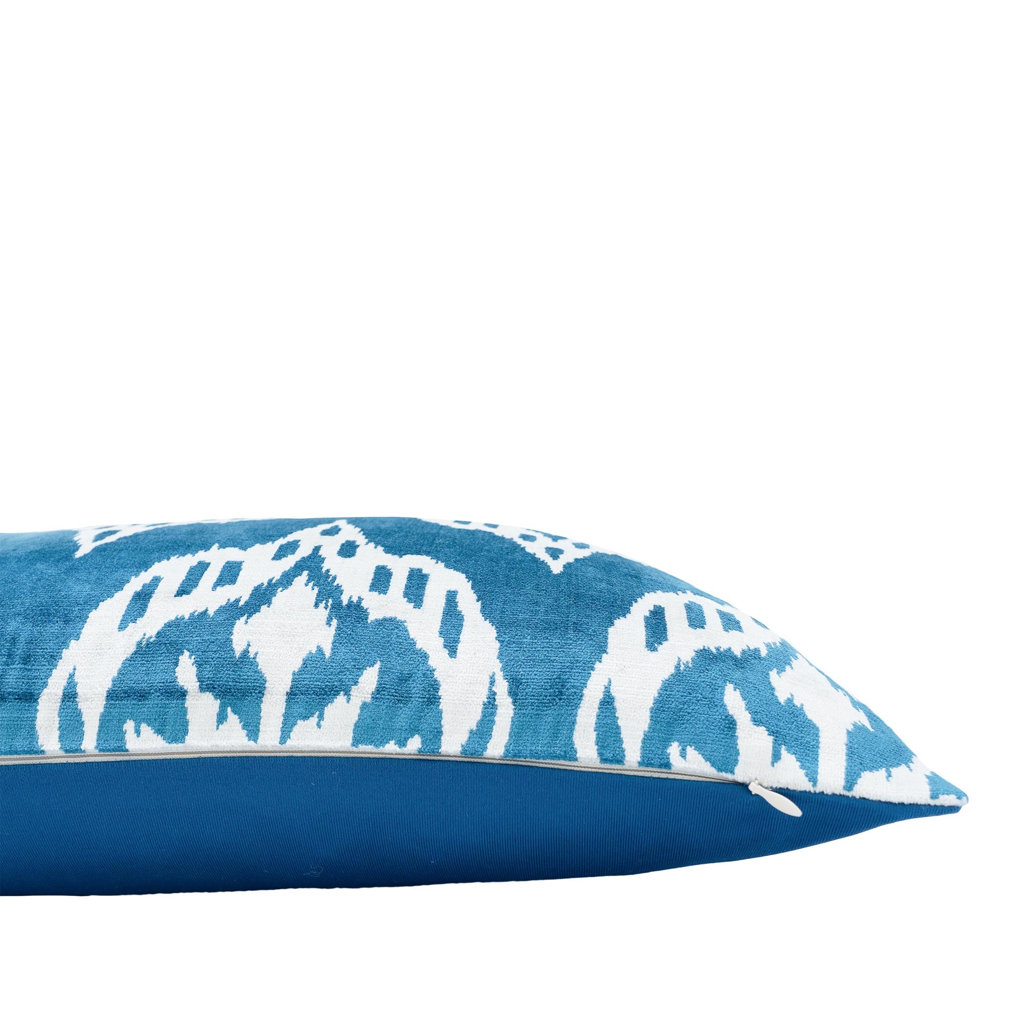 Handmade blue and white silk ikat pillow with traditional Uzbek motif.