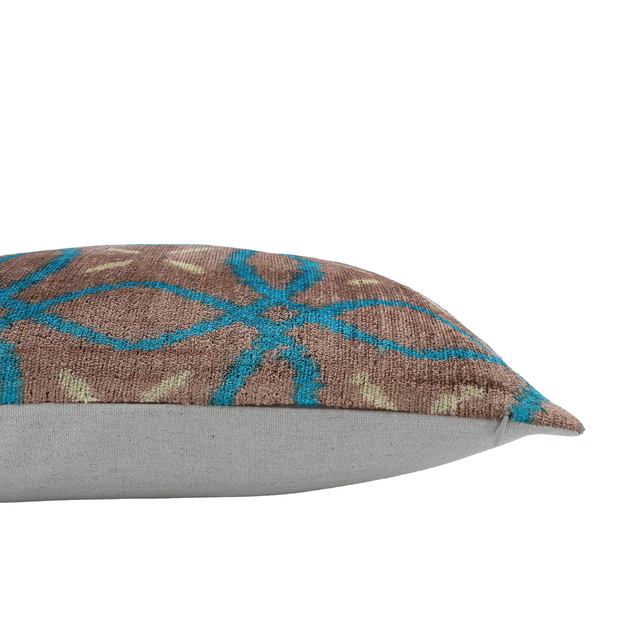 20x20-inch brown silk velvet pillow featuring intricate teal and ivory ikat motif.
