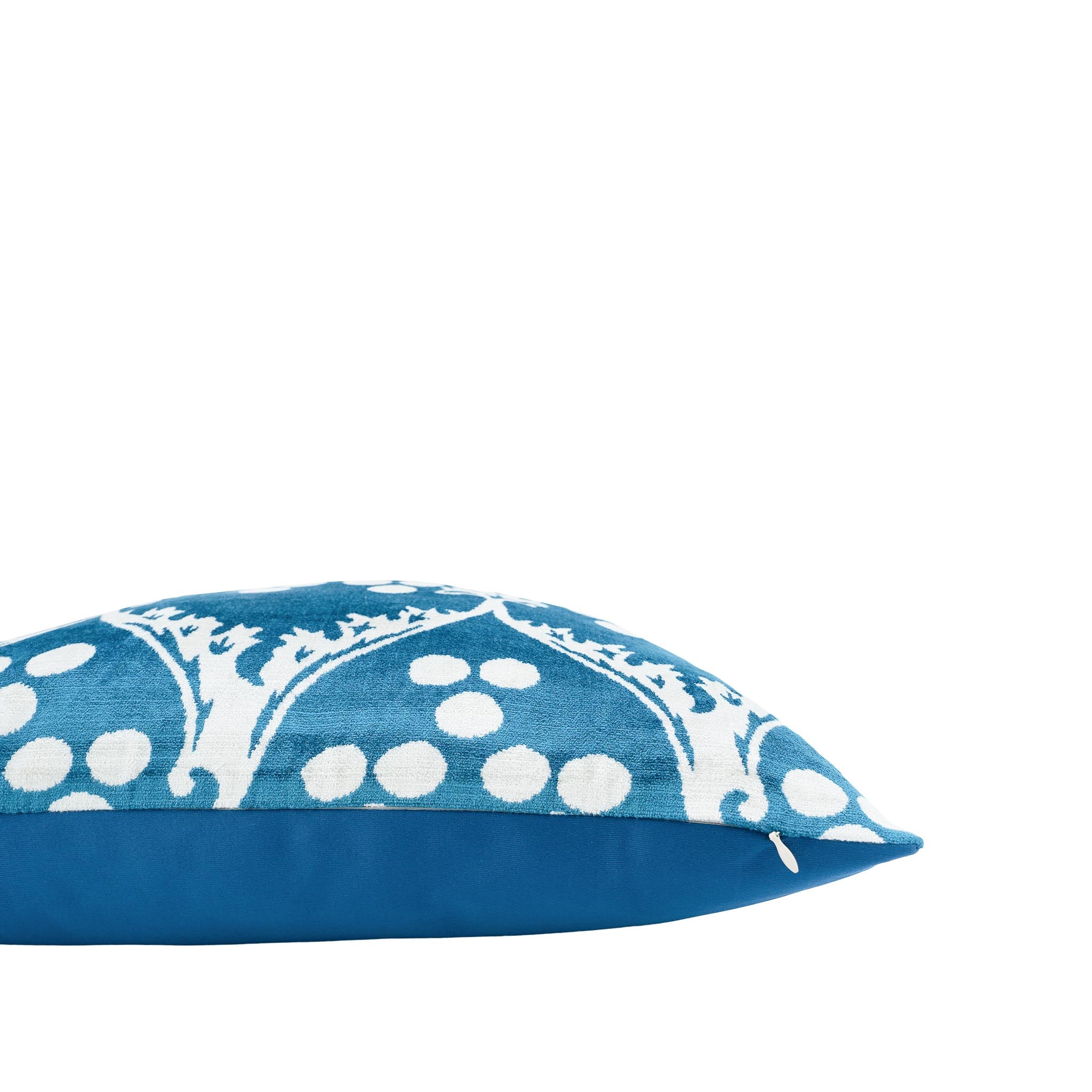 Vibrant blue 20-inch silk velvet pillow with ornate white ikat patterns, adding a touch of elegance.