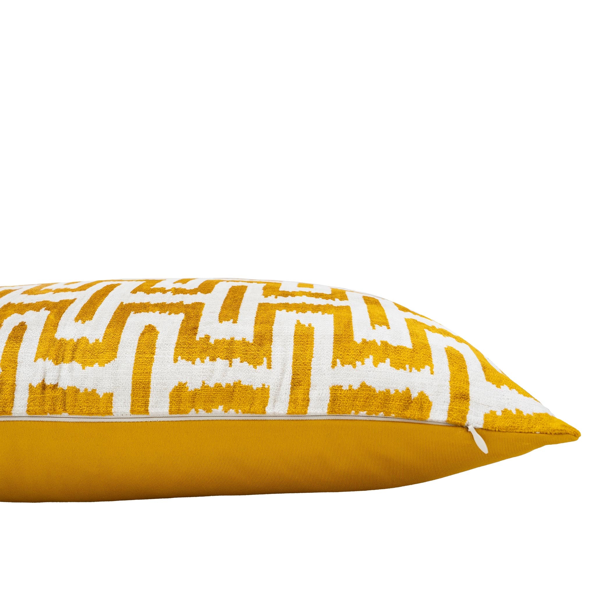 Luxurious silk velvet lumbar pillow with a bold gold and white ikat design, handwoven for elegance.