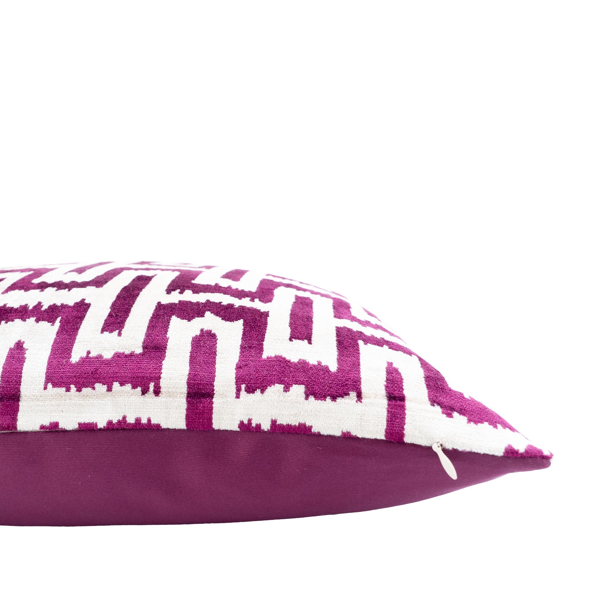 Handwoven silk velvet ikat pillow with a bold purple and white interlocking design, adding a modern touch to interiors.