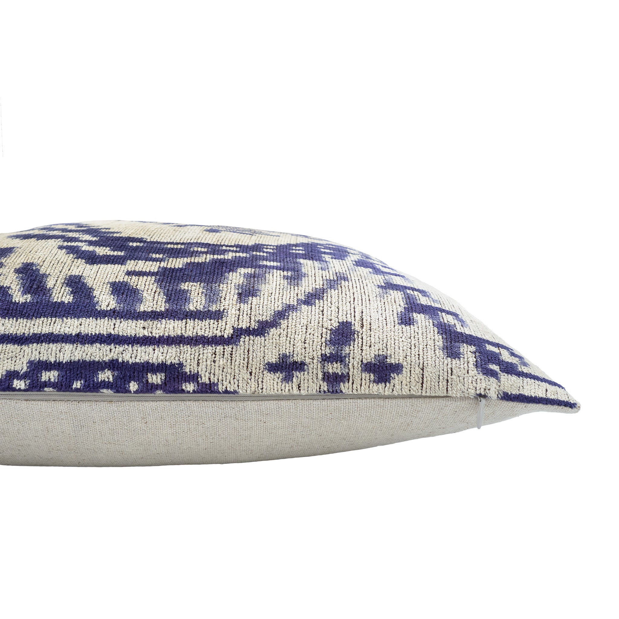 Luxury silk velvet pillow featuring a bold palm-inspired ikat pattern in blue and cream hues.