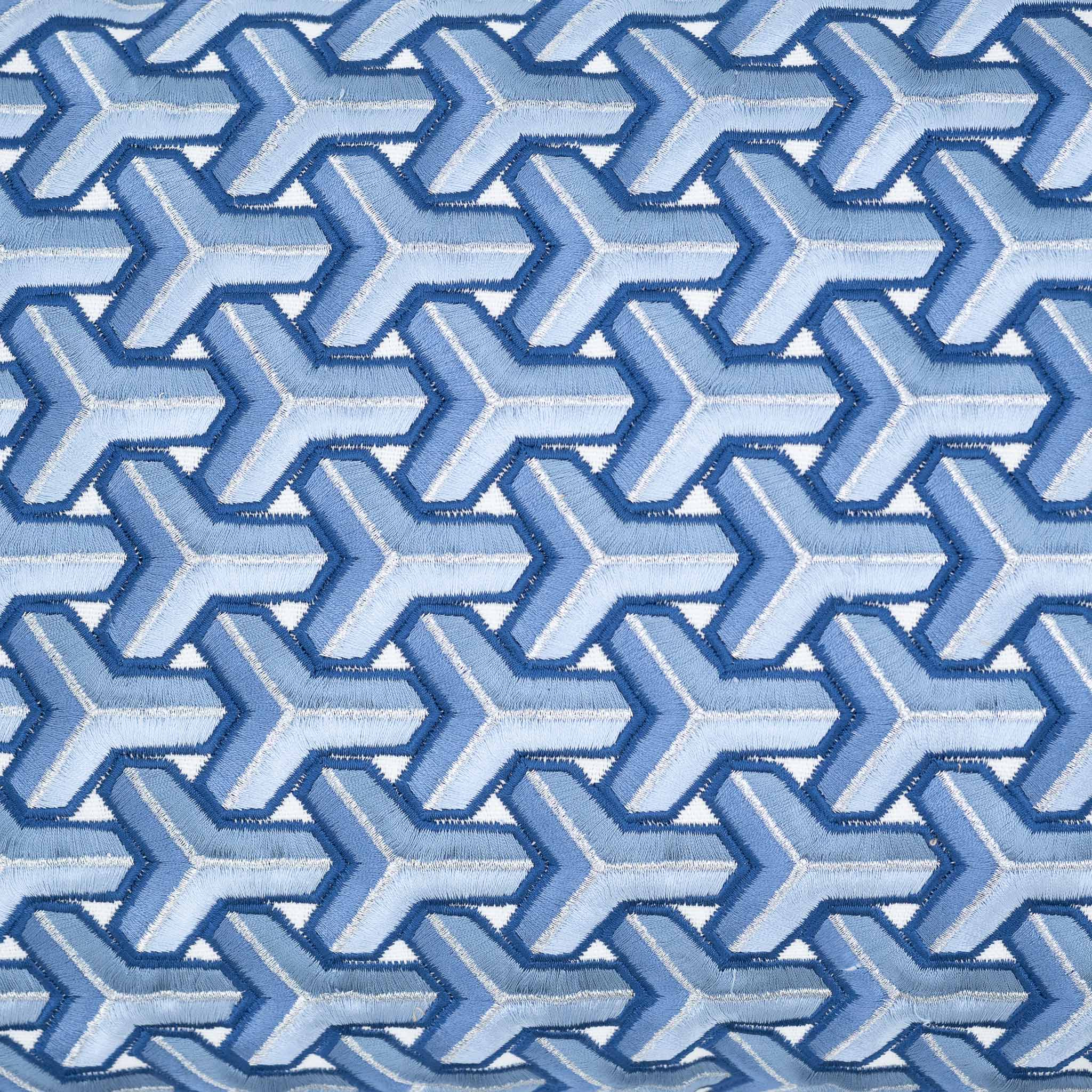Handcrafted Chouchou Touch pillow in blue tones with raised embroidered geometric design.