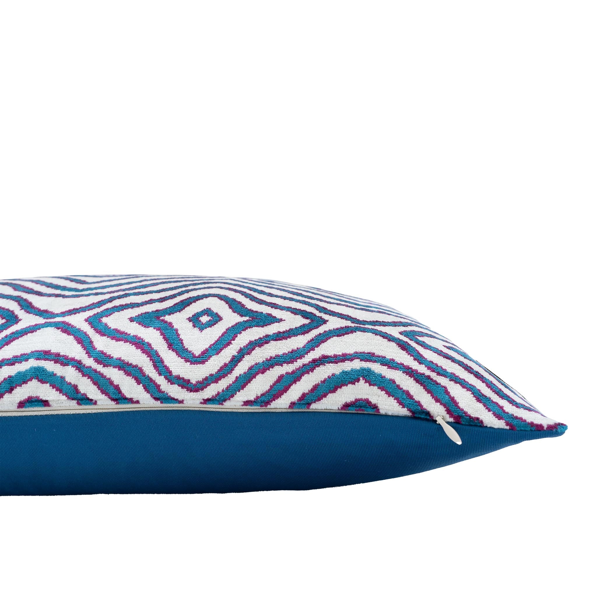 Chouchou Touch handwoven ikat pillow with ripple-like geometric design.