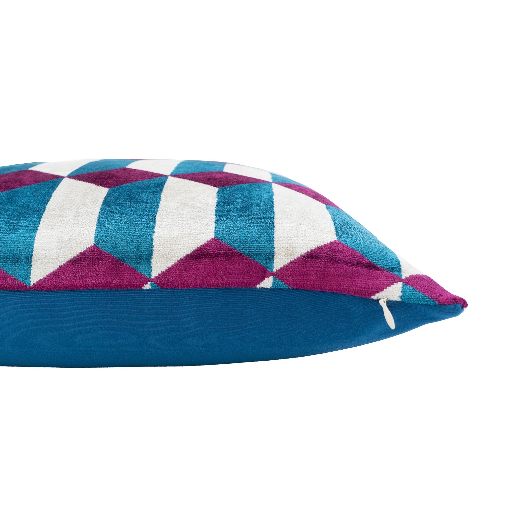 Handwoven silk velvet ikat pillow with a striking 3D diamond pattern in bold magenta, teal blue, and white.