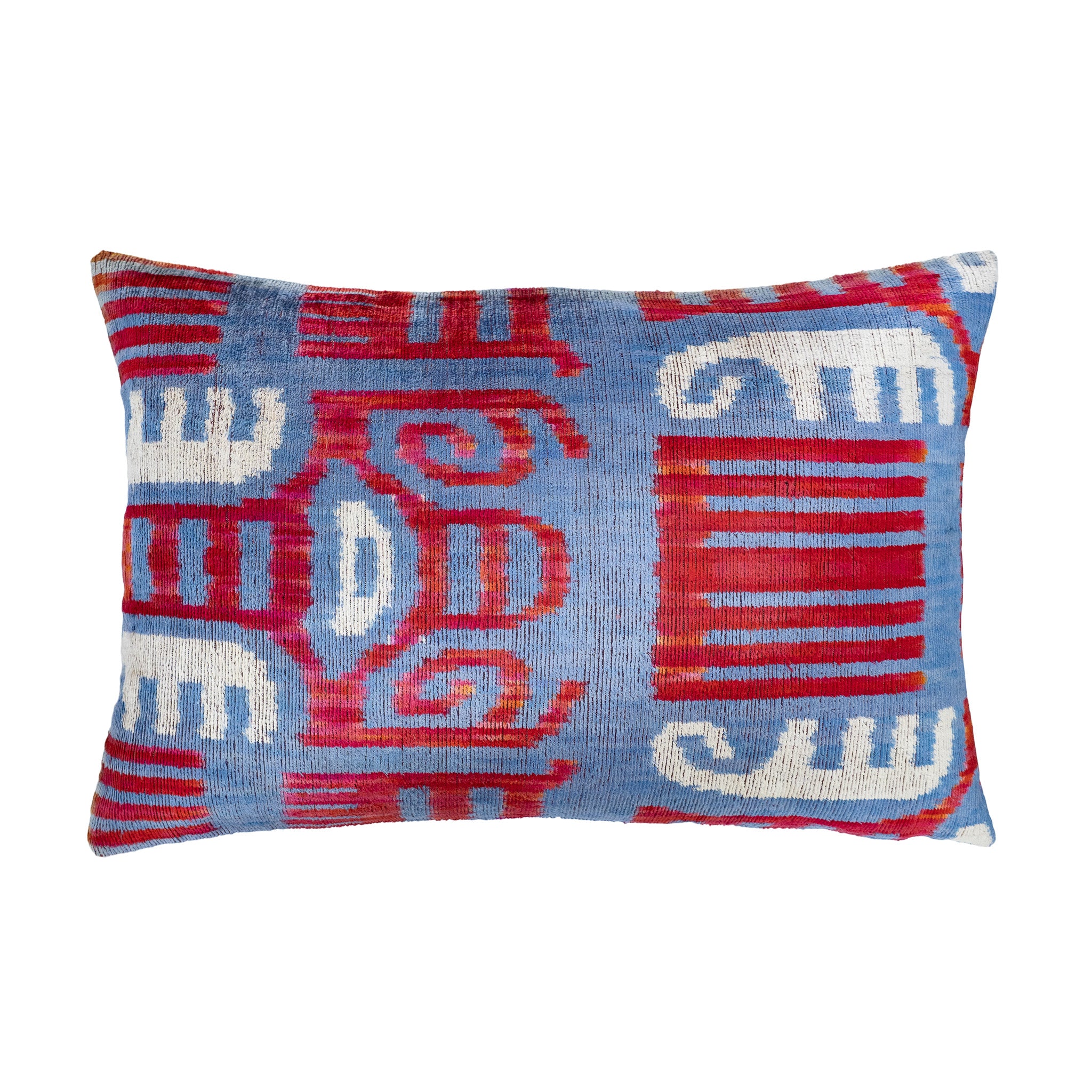 Azteca silk velvet ikat pillow with bold red, white, and blue tribal-inspired motifs.