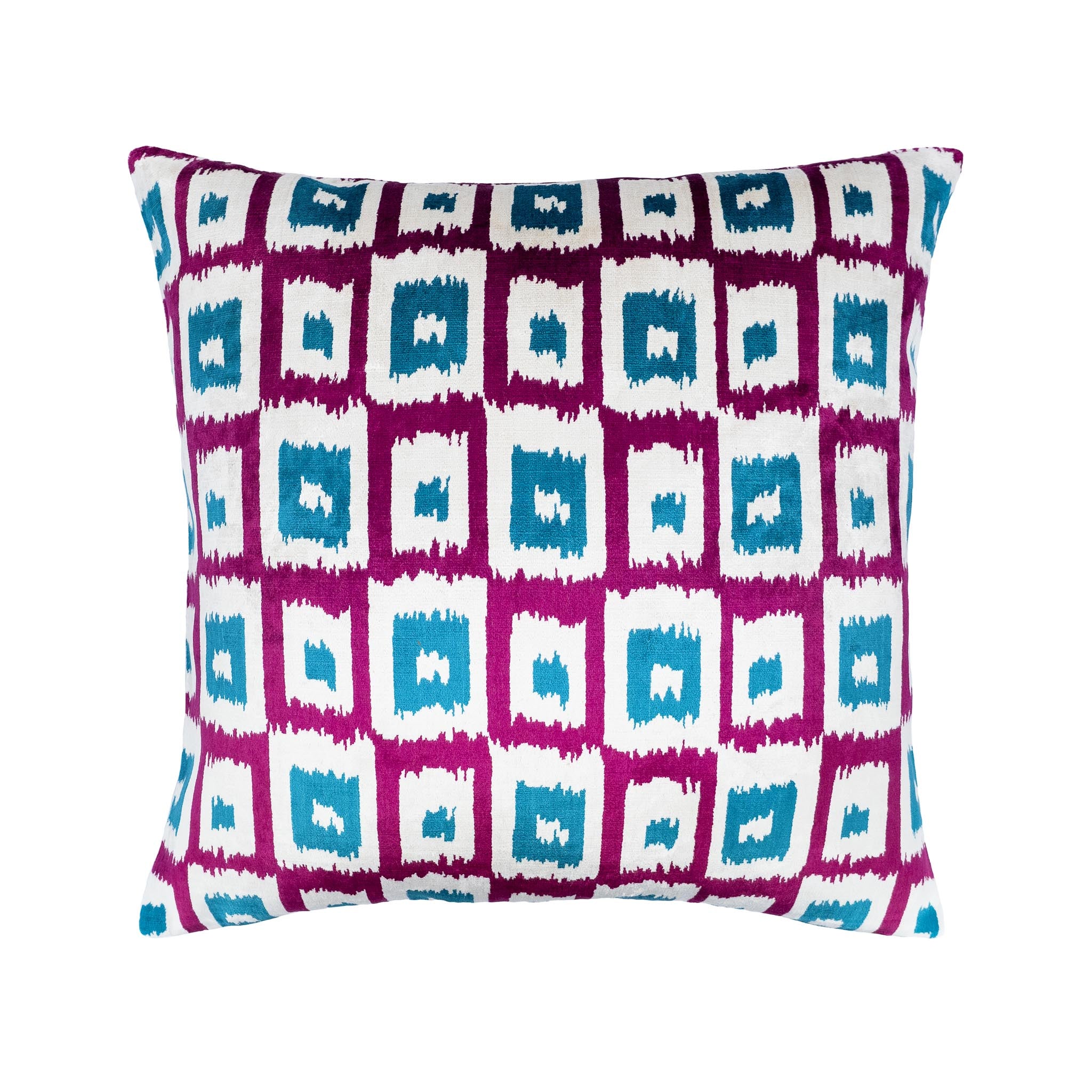 Handwoven silk velvet ikat pillow featuring bold blue squares on a white and purple background.