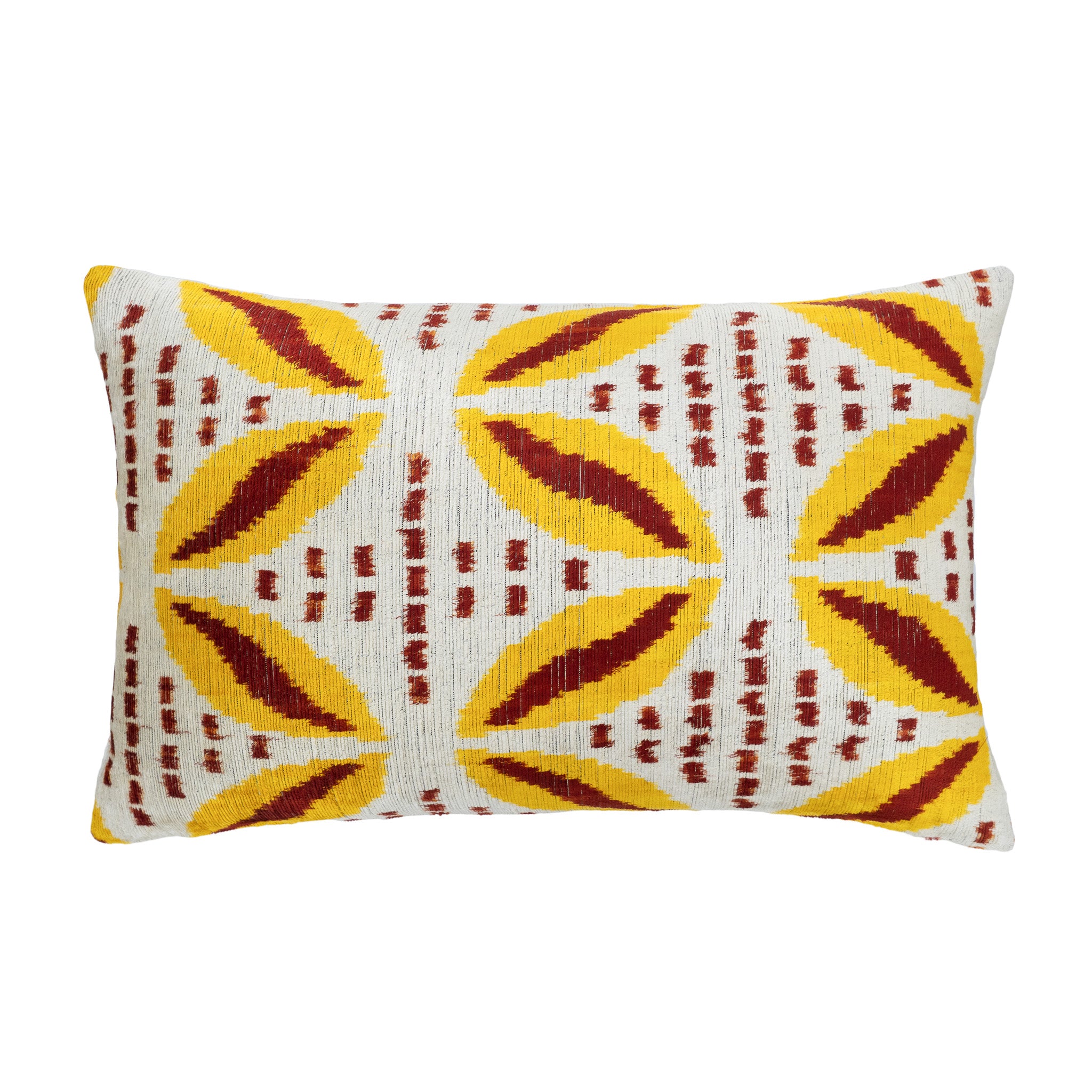 Sunwheel ikat pillow with yellow and red leaf-like pattern on ivory silk velvet.