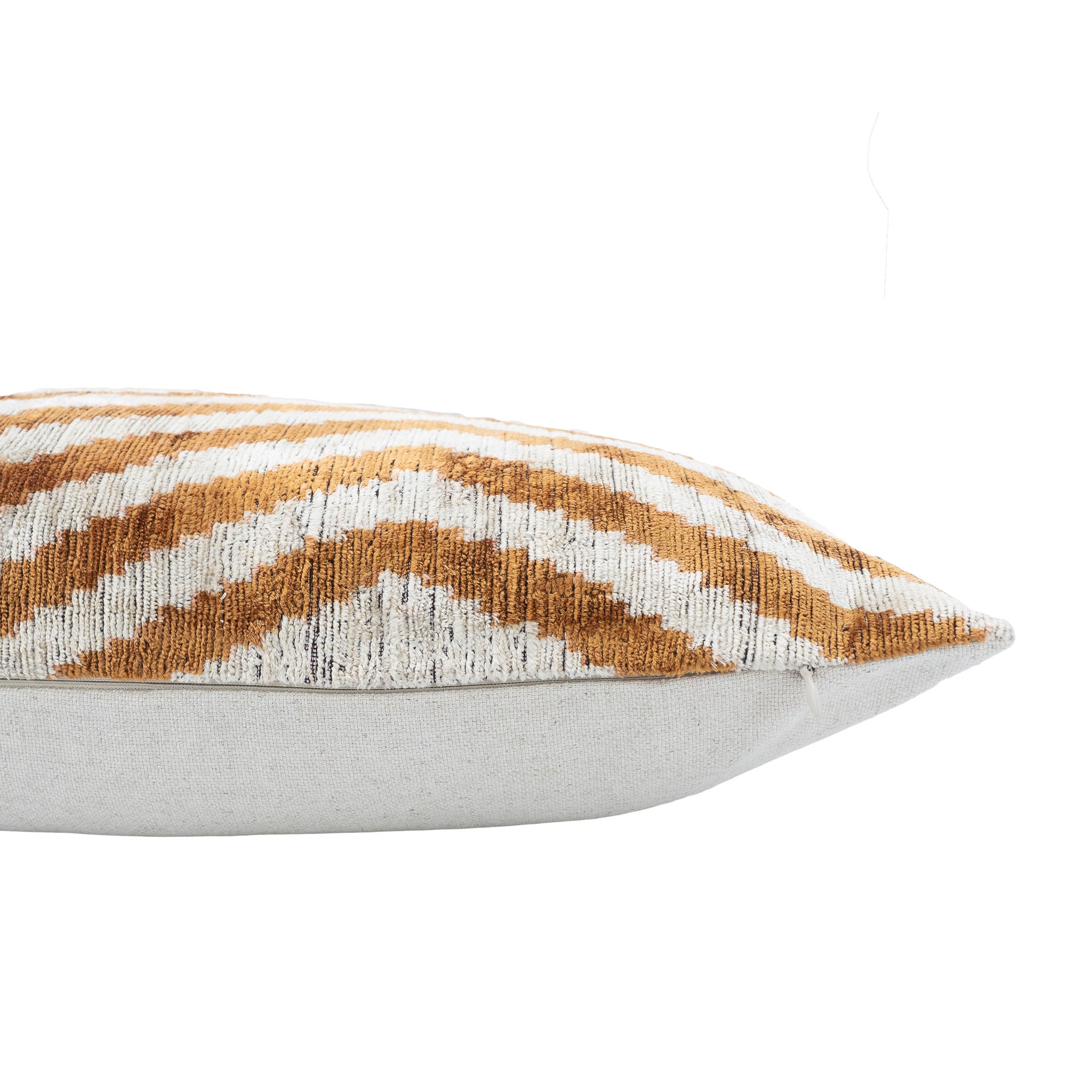 Handmade silk velvet pillow with concentric diamond ikat design in golden brown.