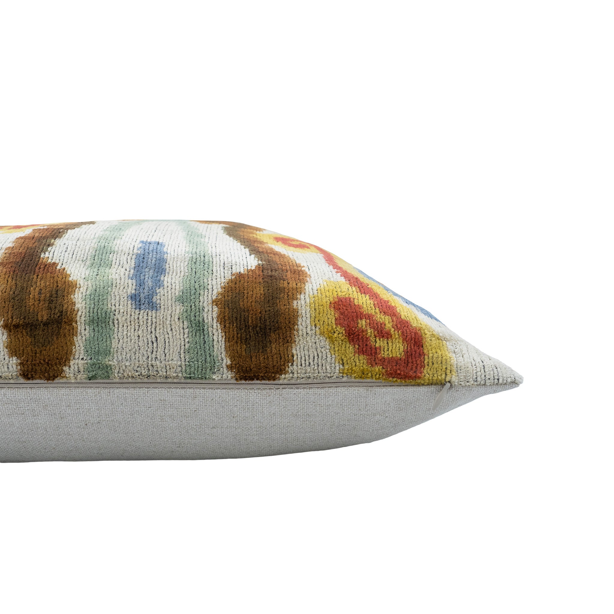 Handwoven silk velvet ikat pillow featuring a vibrant, artistic design in soft pastel hues.