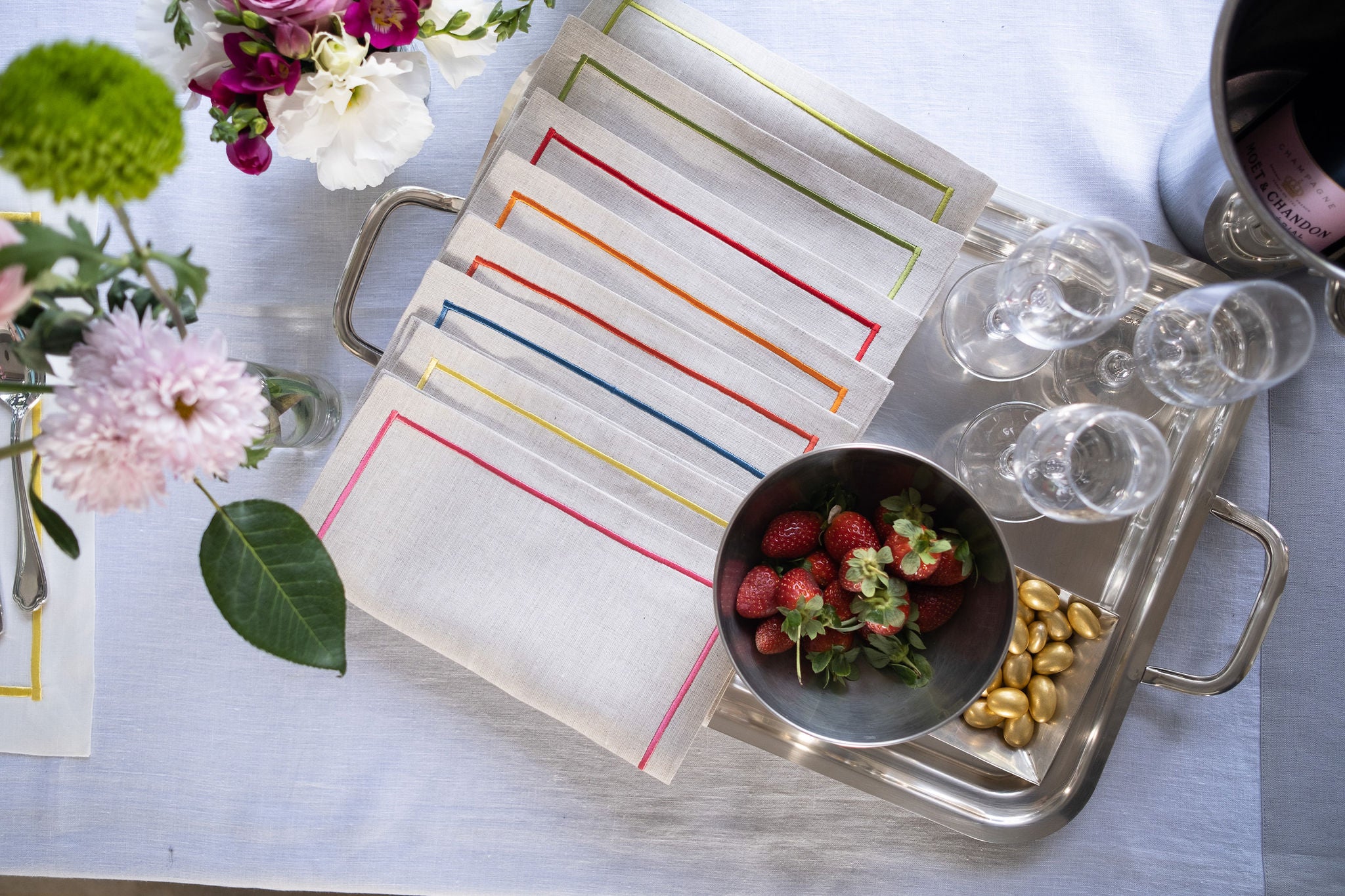 Colorful linen cocktail napkins with embroidered borders, crafted to bring a touch of elegance to any occasion.
