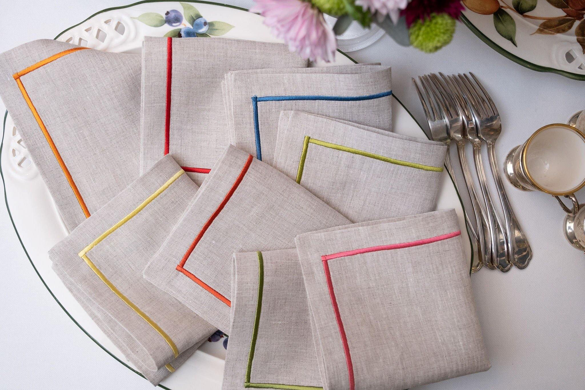 Durable linen cocktail napkins with decorative embroidered borders, machine washable for easy care and long-lasting beauty.
