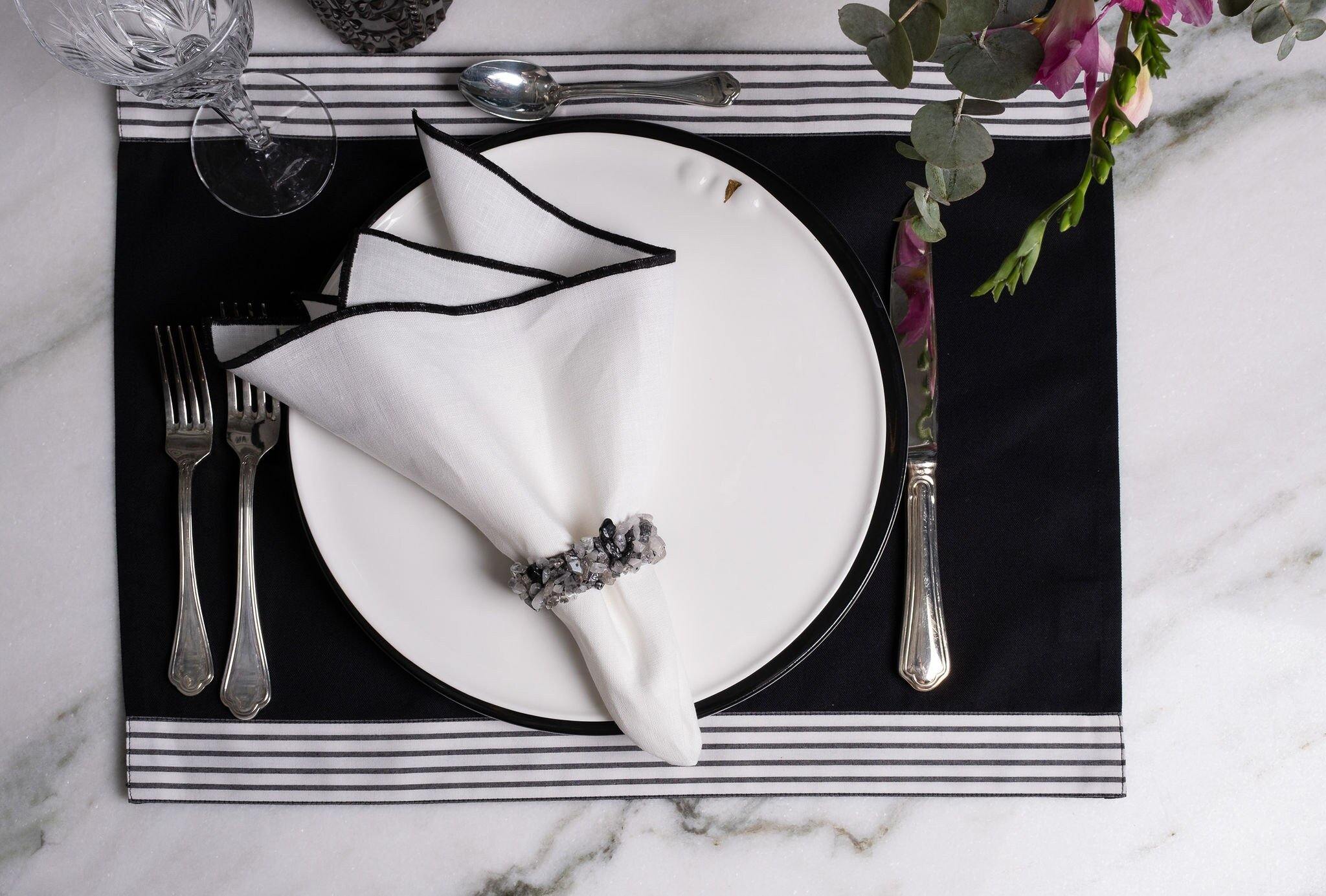 Set of 4 black placemats with top and bottom stripes, crafted with precision to add sophistication to any dining setup.