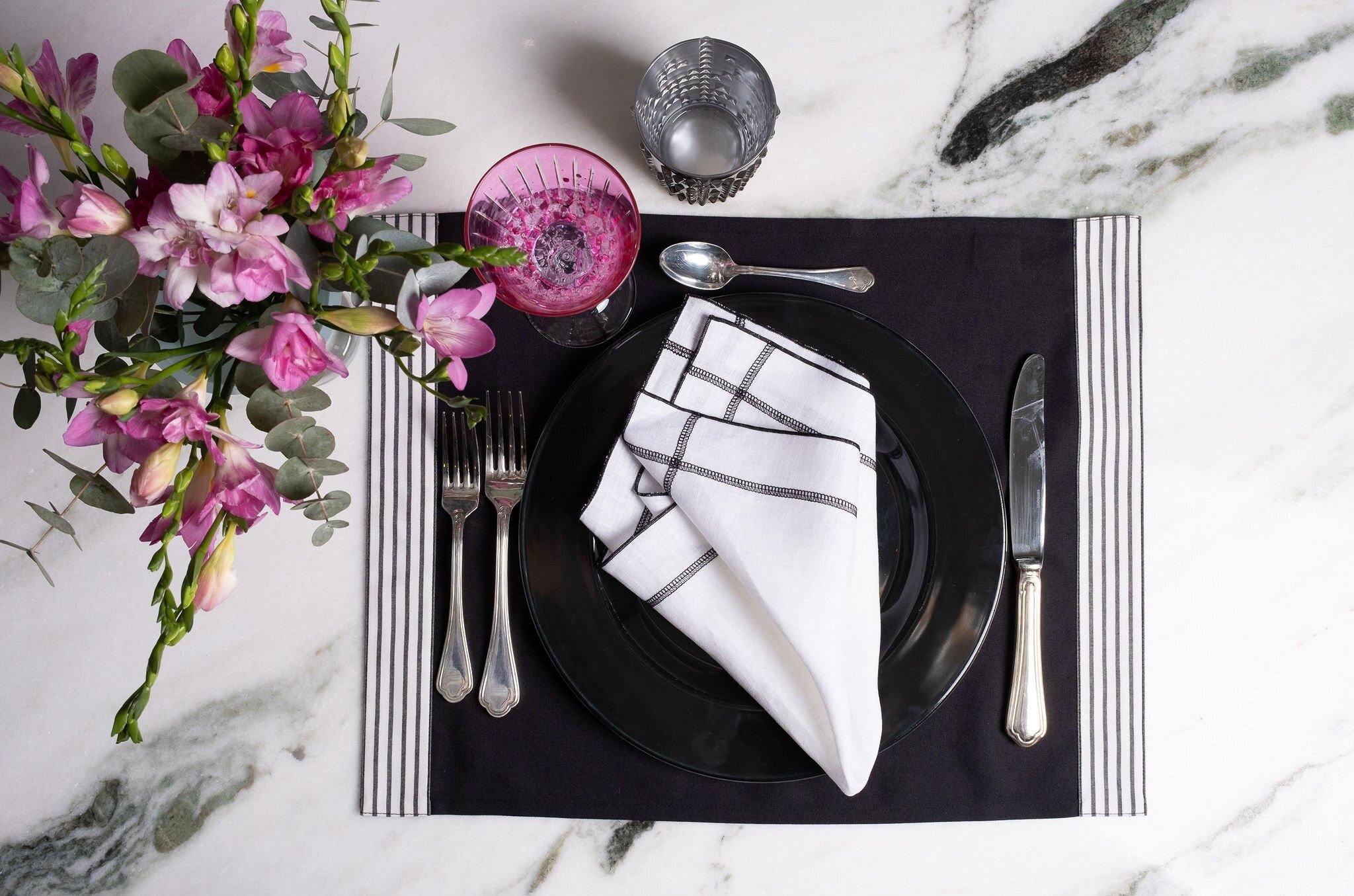 Elegant black placemats with side stripes, anti-wrinkle, machine washable, and perfect for both casual family meals and formal gatherings.
