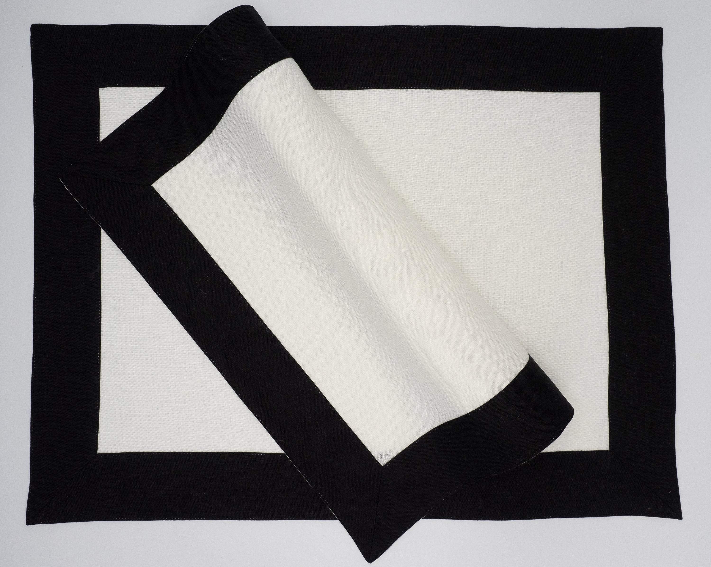 Set of 4 white linen placemats with black borders, designed to enhance your table setting for both formal and casual occasions.