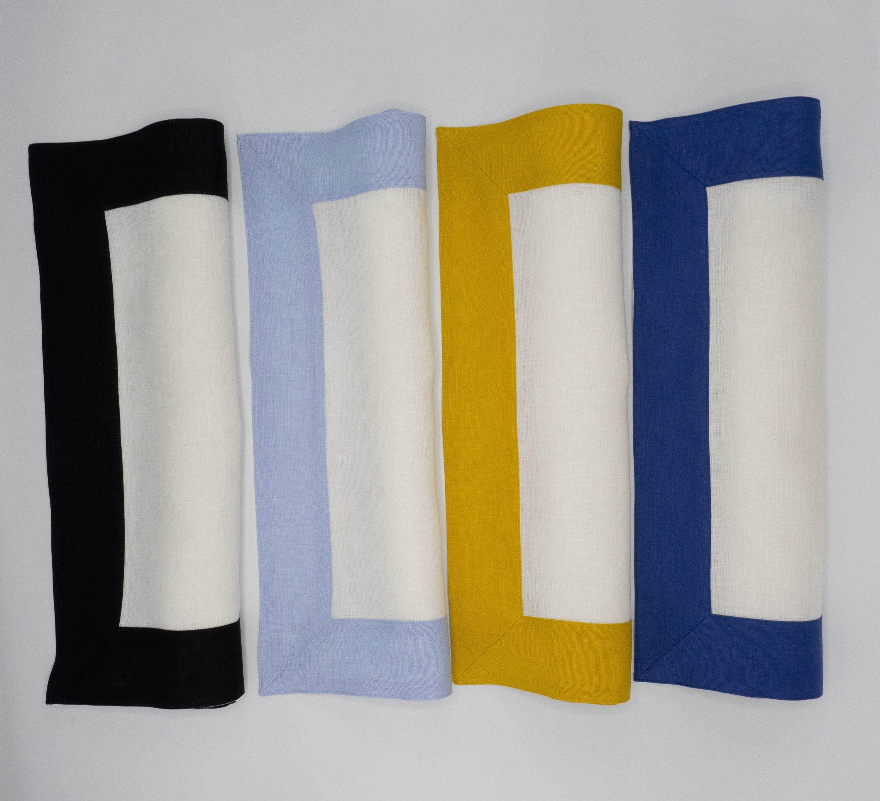 Chouchou Touch white linen placemats with black borders, combining premium construction with a sleek, modern look for your dining needs.