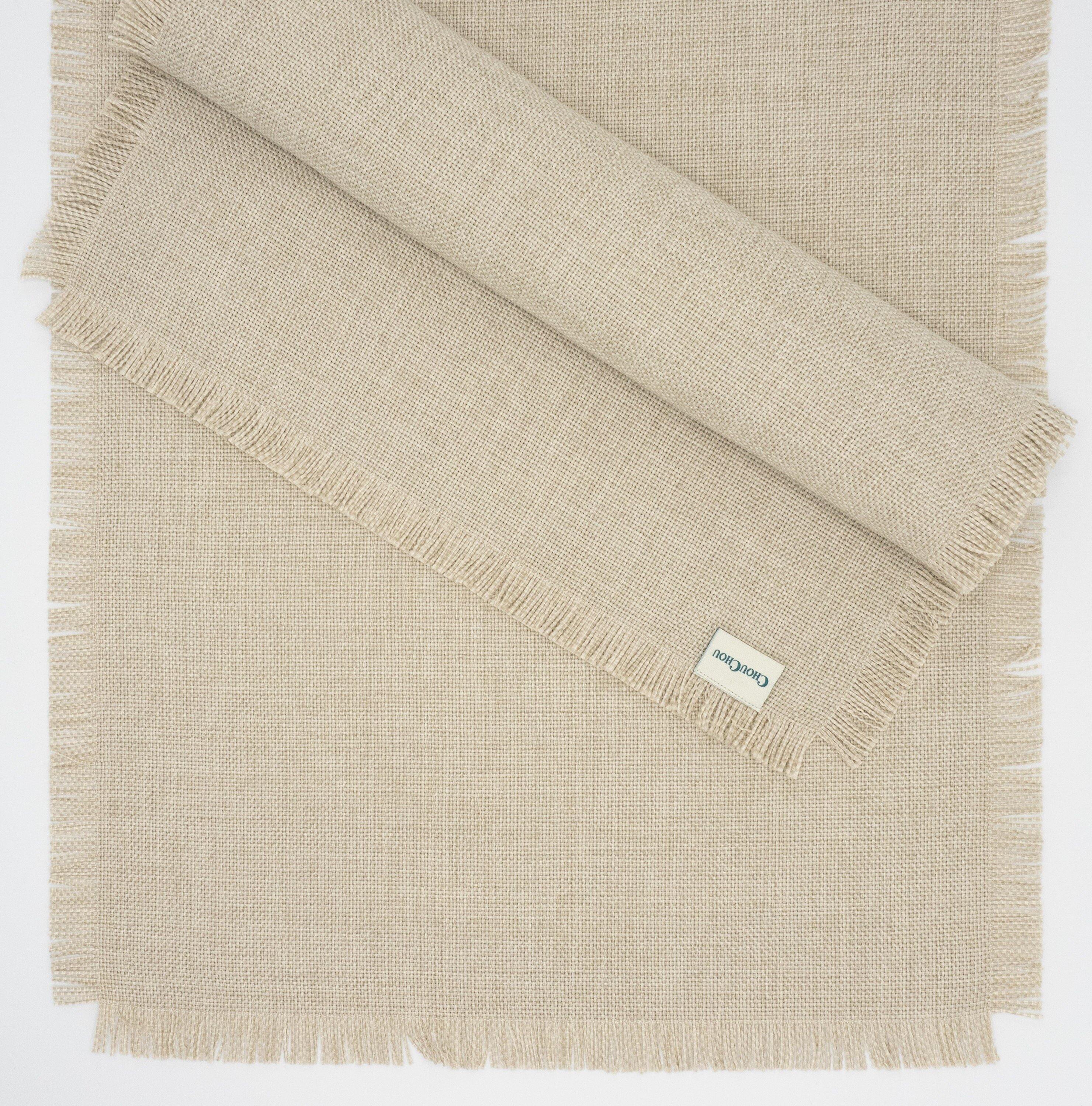 Chouchou Touch beige placemats with fringes, 15" x 20", crafted by skilled artisans to enhance your tabletops with a timeless design.