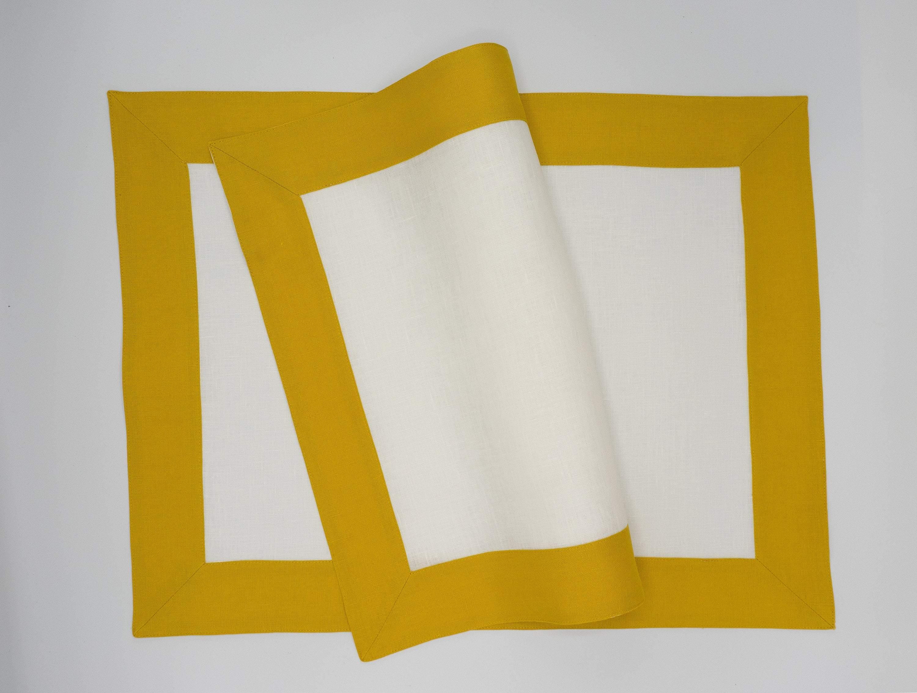 Handcrafted linen placemats with mustard borders, perfect for adding warmth and elegance to your dining experience.