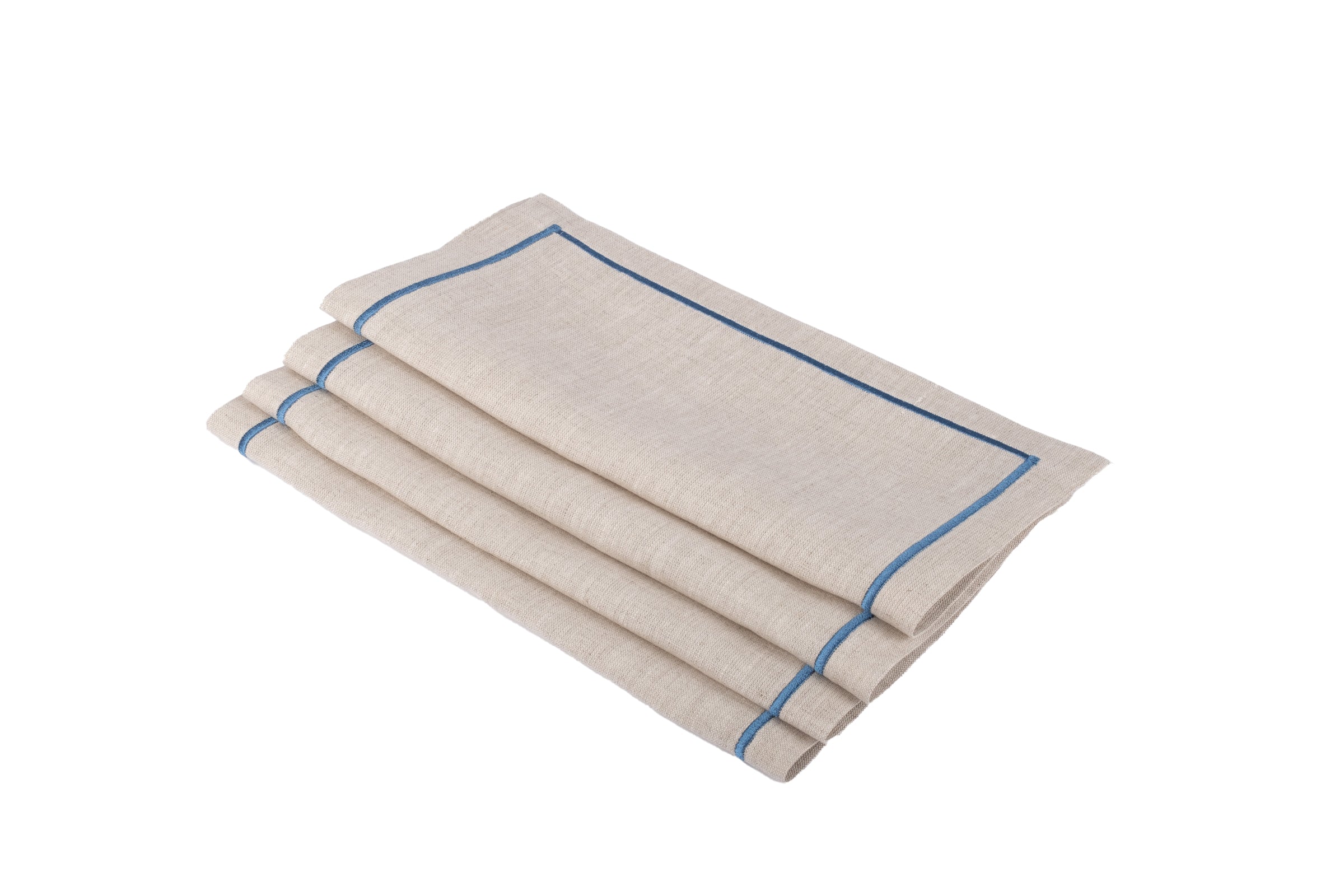 Close-up of linen cocktail napkin with blue embroidered border and natural linen texture