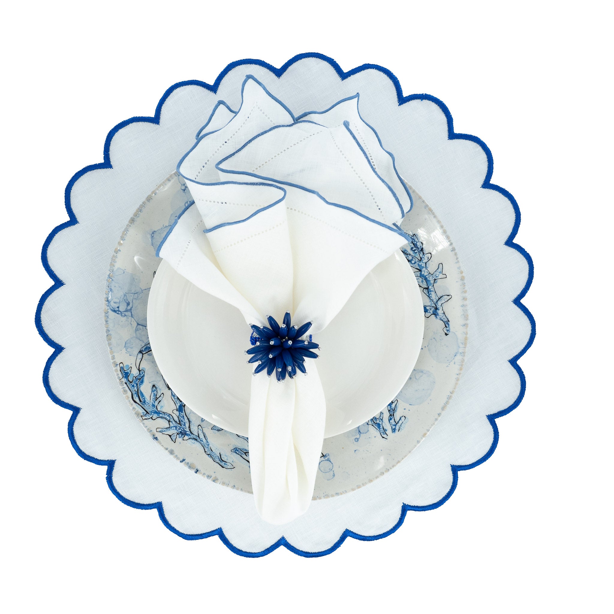 Durable white linen napkins with blue ruffled hemstitch edges, machine washable, designed for luxurious and tactile dining.