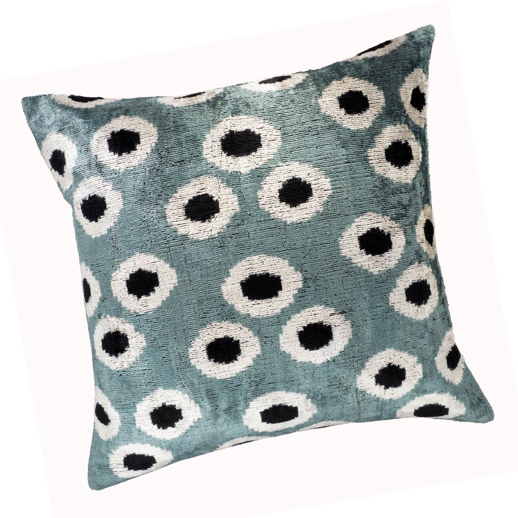 Handcrafted Ikat pillow cover with orb-shaped patterns, combining teal, white, and black tones in luxurious silk velvet.
