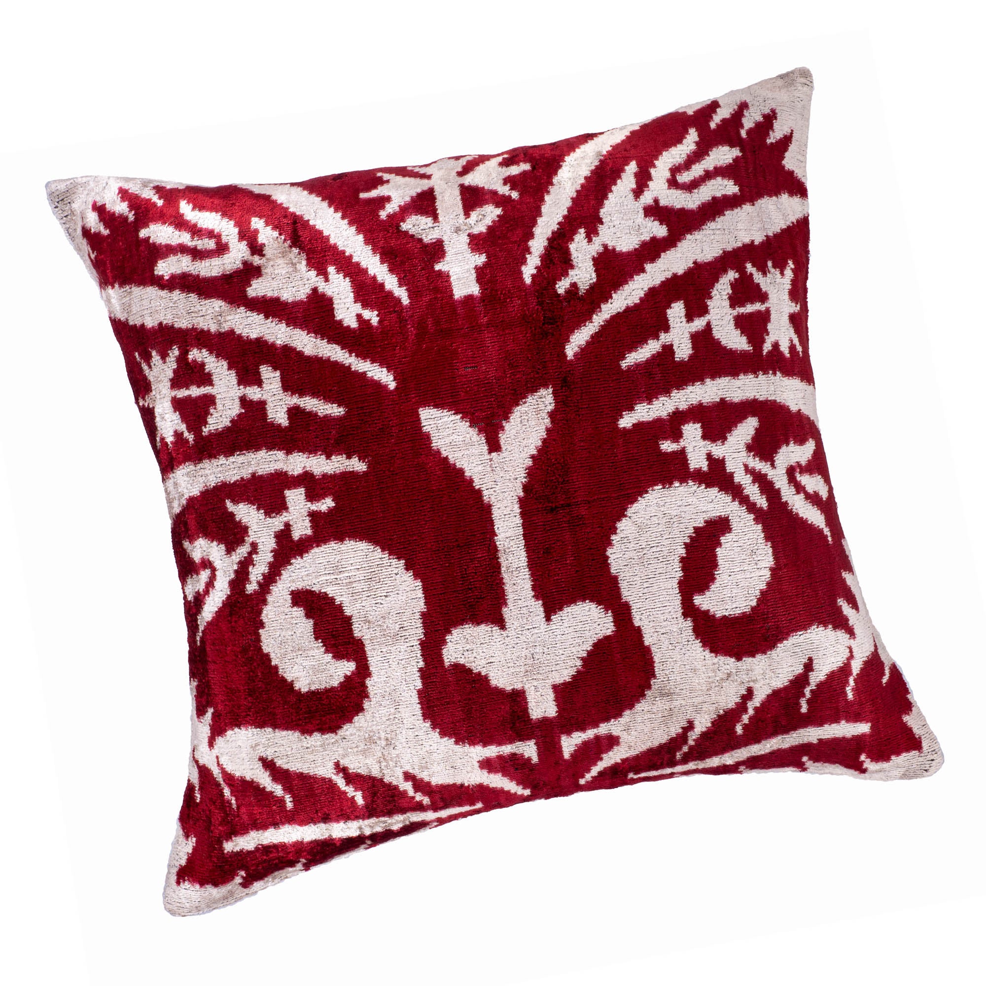 Peacock Ikat pillow with rich red tones and a striking white floral pattern, 20" x 20".
