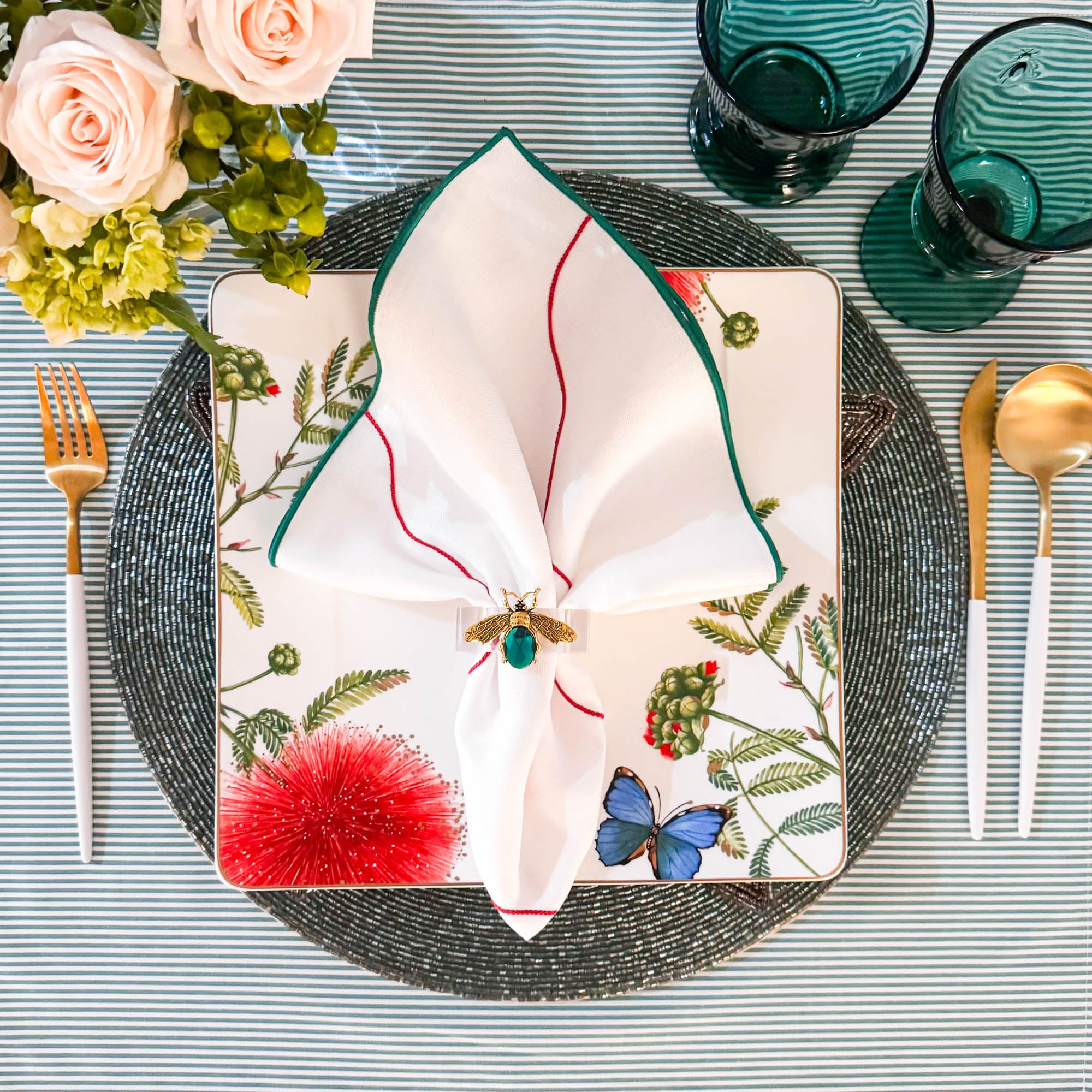 Close-up of Starfish glass beaded placemat with vibrant beads in turquoise, white, green, and red, backed with cotton lining.
