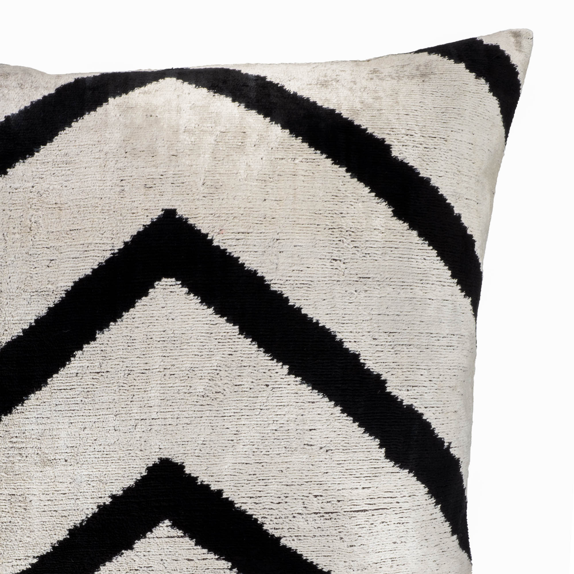 Chevron-style silk velvet Ikat pillow in silver and black, offering timeless elegance for your living space.
