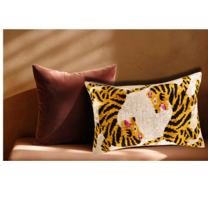 Bengali ikat velvet throw pillow styled on an elegant sofa with neutral tones, adding color and texture to a sophisticated interior