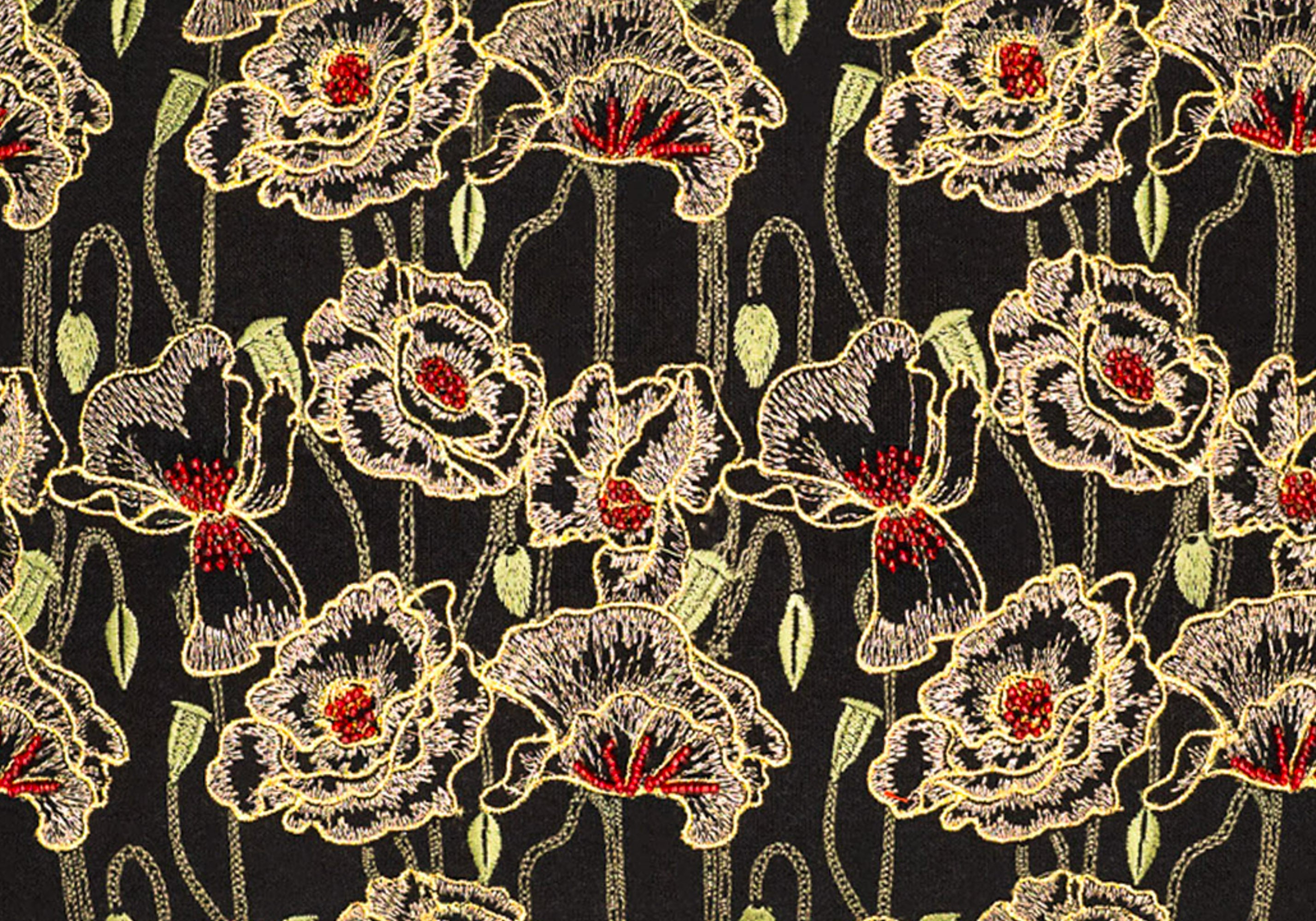 Close-up detail of black linen lumbar pillow cover featuring intricate orchid embroidery and red trim