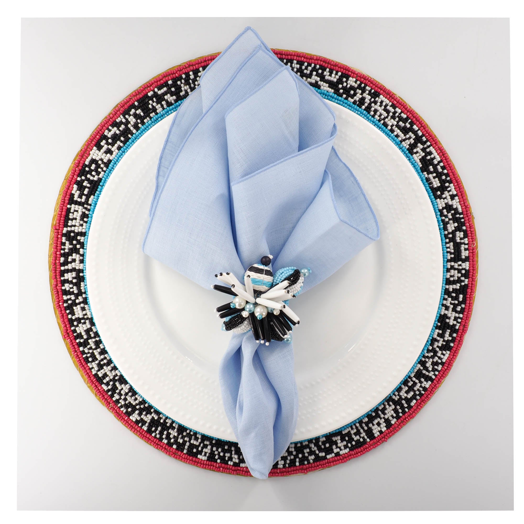 Luxury handmade blue linen napkin styled on multicolor bead placemat for elegant dining table