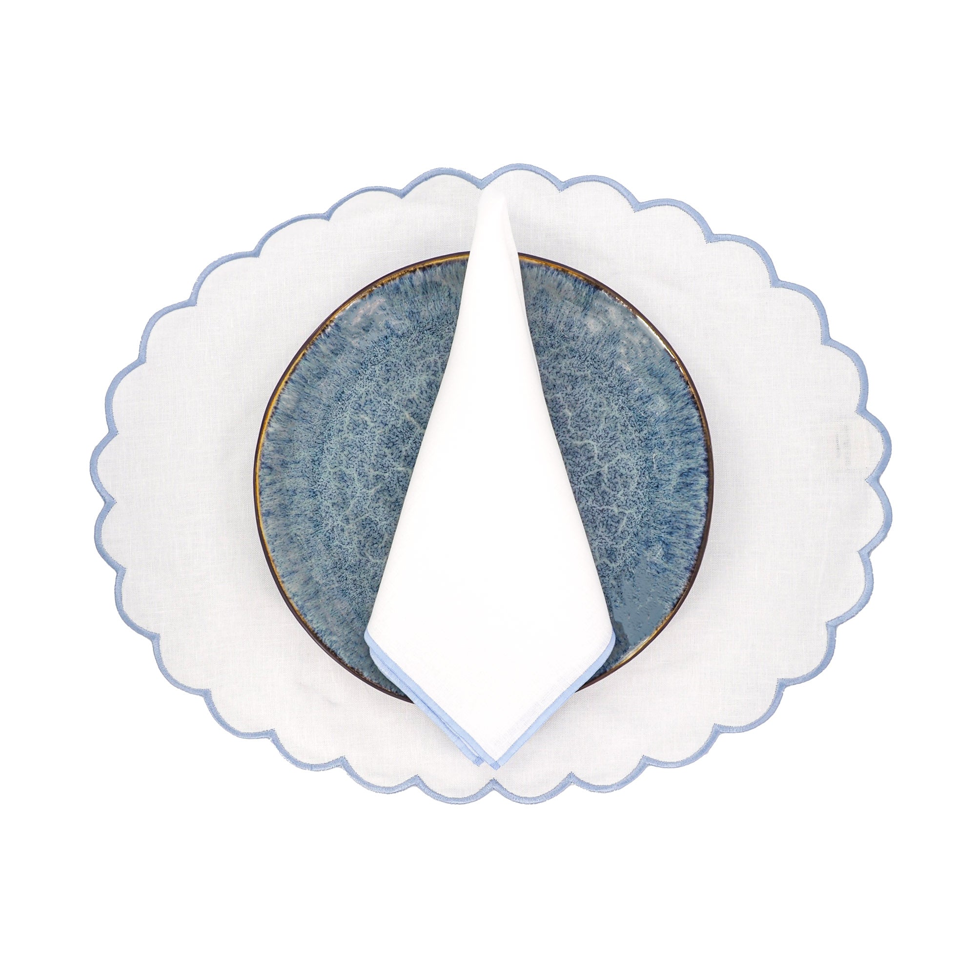 Blue linen scalloped placemat styled on an elegant dining table - ideal for dinners, weddings, holiday entertaining, brunches, and formal coastal dinner parties, designed by ChouChou Touch.
