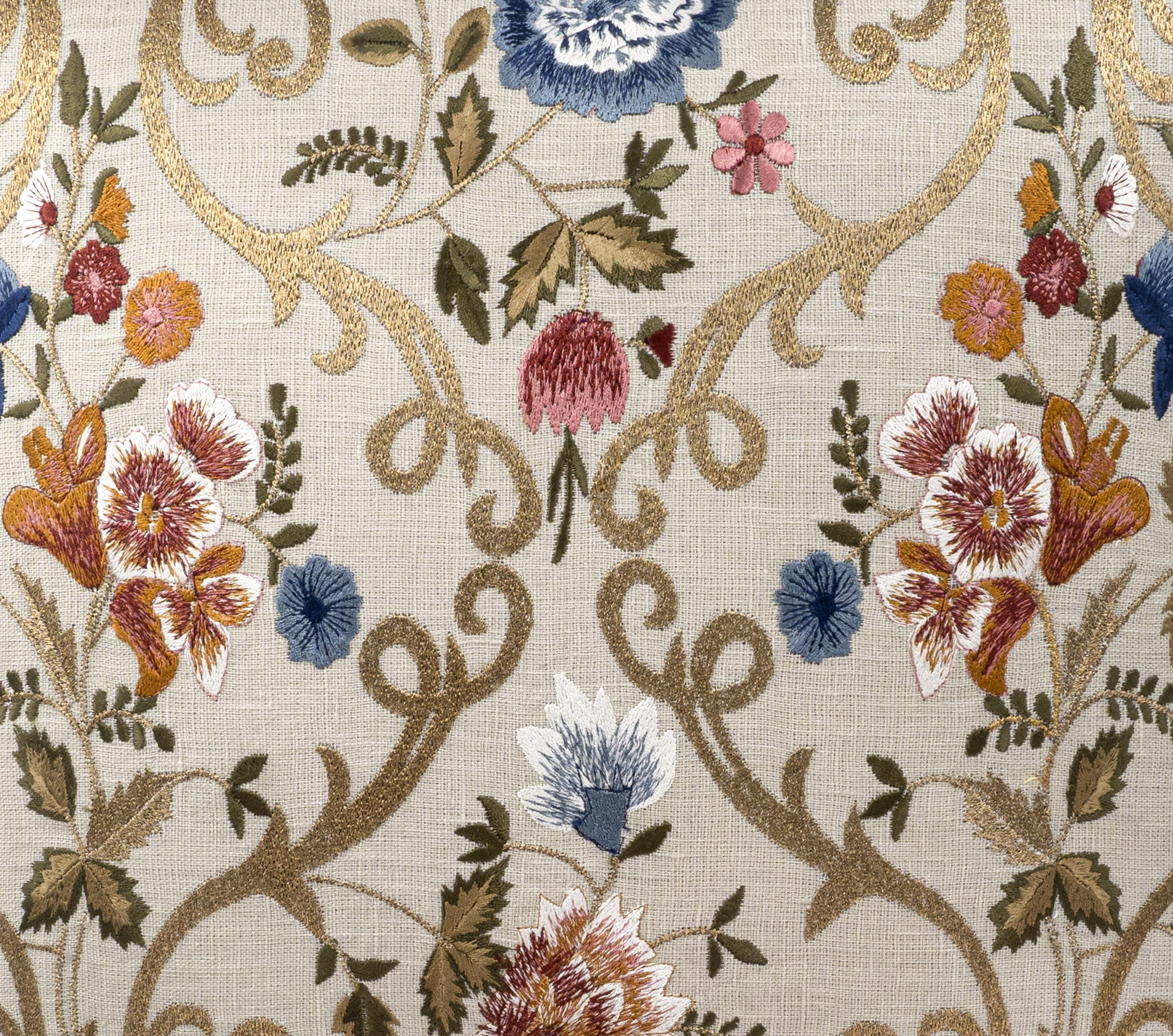 Close-up of hand-embroidered linen throw pillow cover featuring intricate Chantilly floral design with blue, red, green, pink, white and gold silk threads on a natural linen base by ChouChou Touch