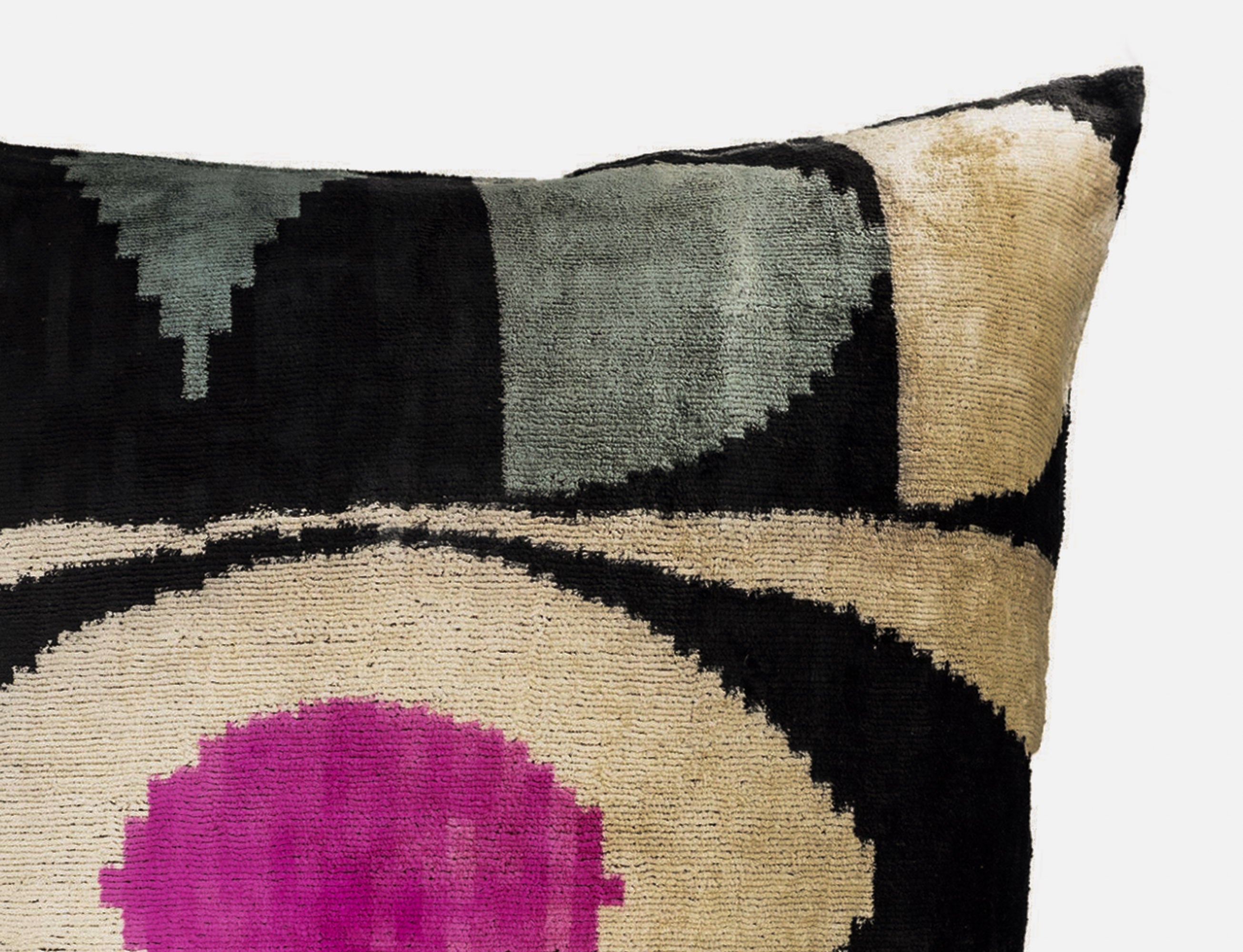Close up of Eye of Ra silk velvet ikat pillow cover 24x24 highlight pink center and silk texture