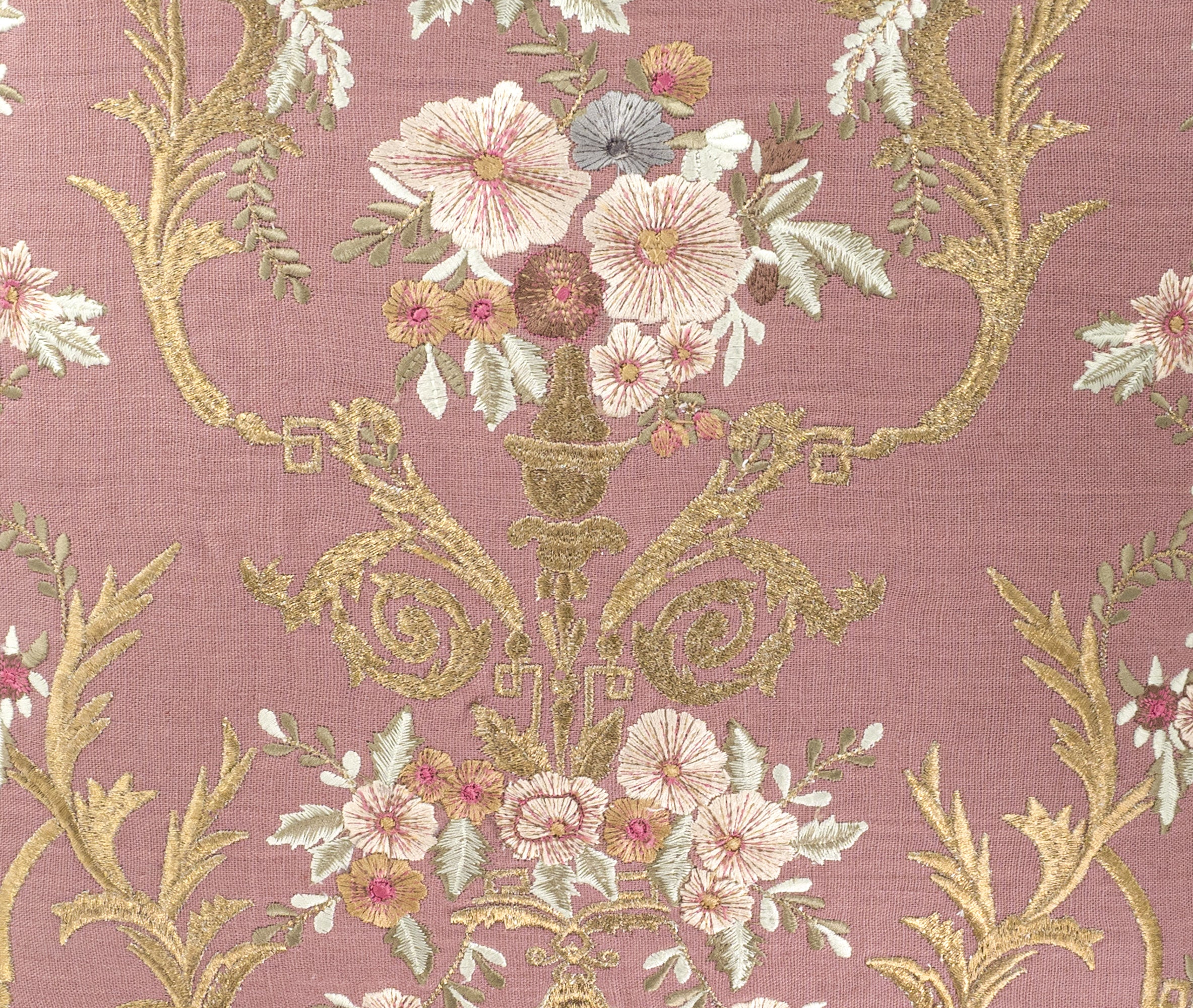 Close up detail of floral silk embroidery on blush pink linen decorative pillow