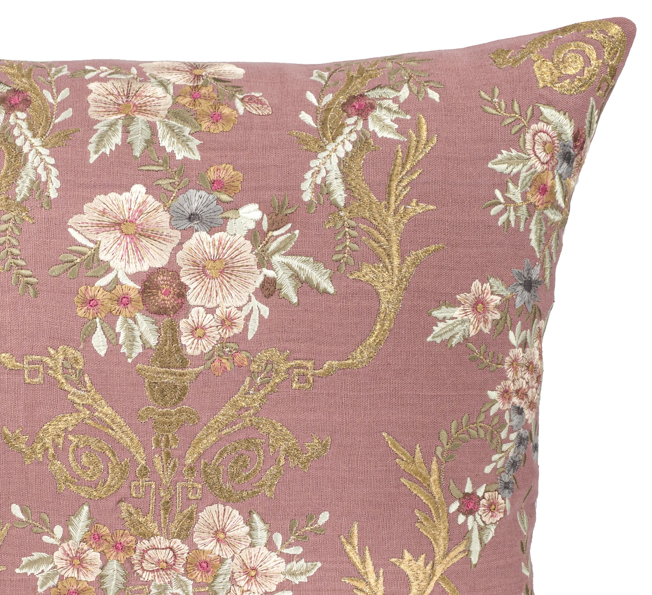 Close up photo of elegant vintage-style square pillow cover in mauve linen with intricate floral embroidery.