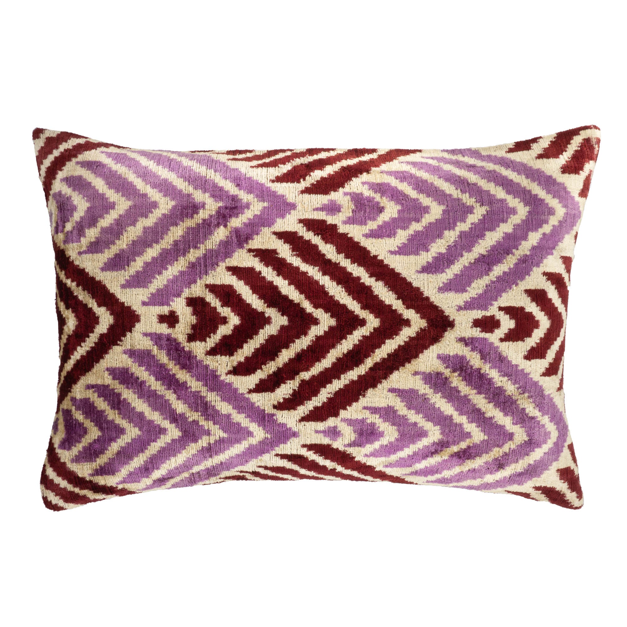 Handwoven Ikat silk velvet pillow cover with intricate chevron-inspired patterns in rich burgundy and soft lavender hues.
