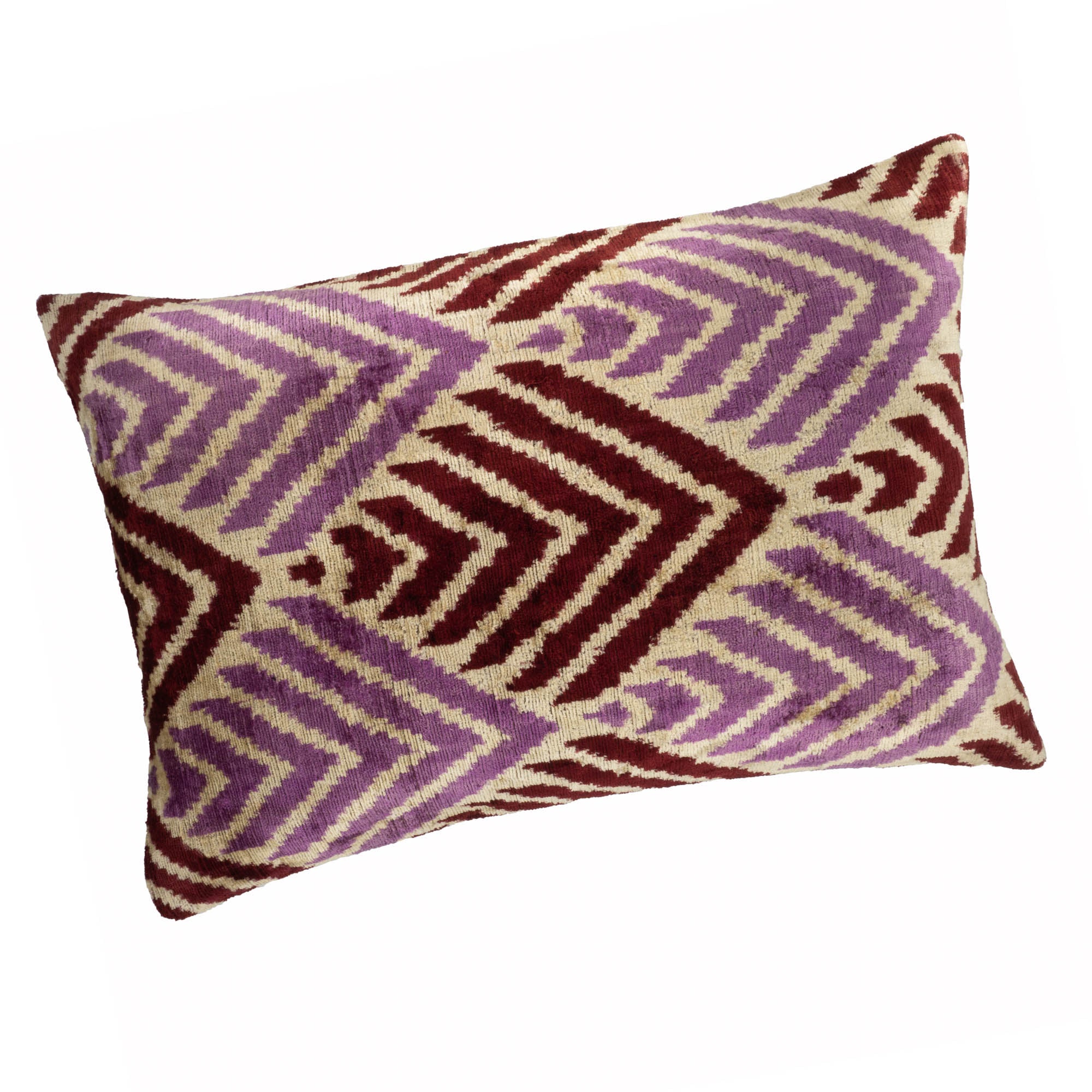 Artisanal silk velvet throw pillow in a vibrant Ikat pattern, blending traditional craftsmanship with modern aesthetics.
