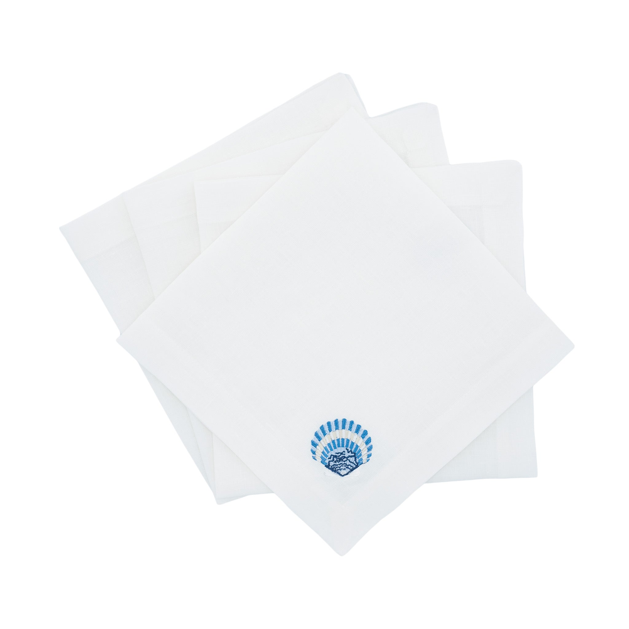 Luxurious linen napkins with blue shell embroidery, designed to enhance your tabletops with a charming nautical accent.