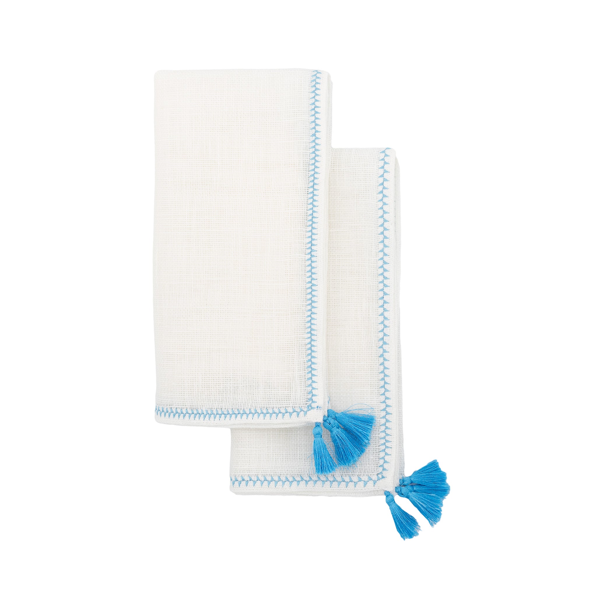 Close-up of linen napkin featuring blue tassels, crafted from 100% high-quality linen for a refined dining experience.