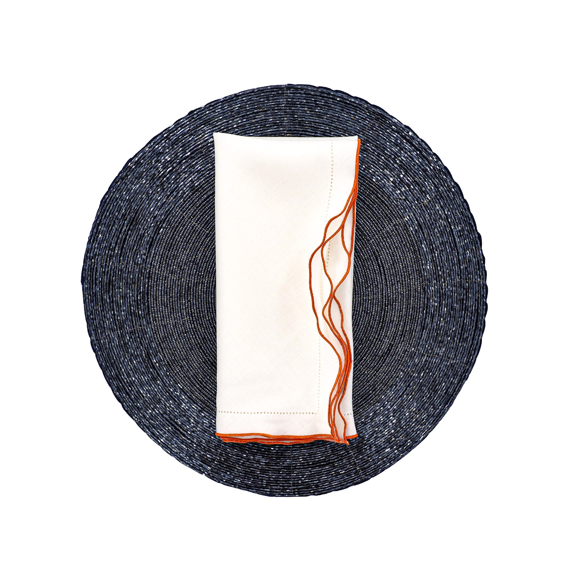Luxury white linen napkin with orange ruffled trim on a round blue placemat, modern table decor