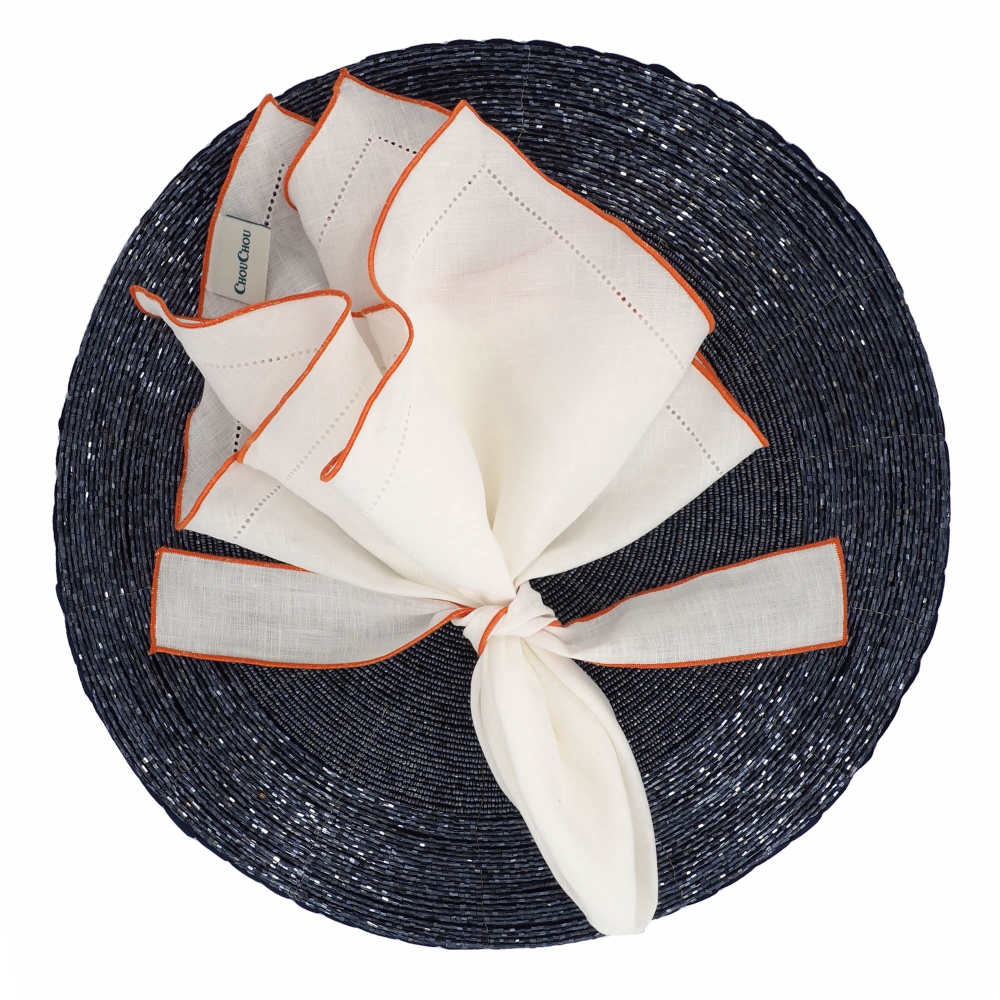 Durable white linen napkins with orange ruffled hemstitch edges, machine washable, designed for luxurious and tactile dining.