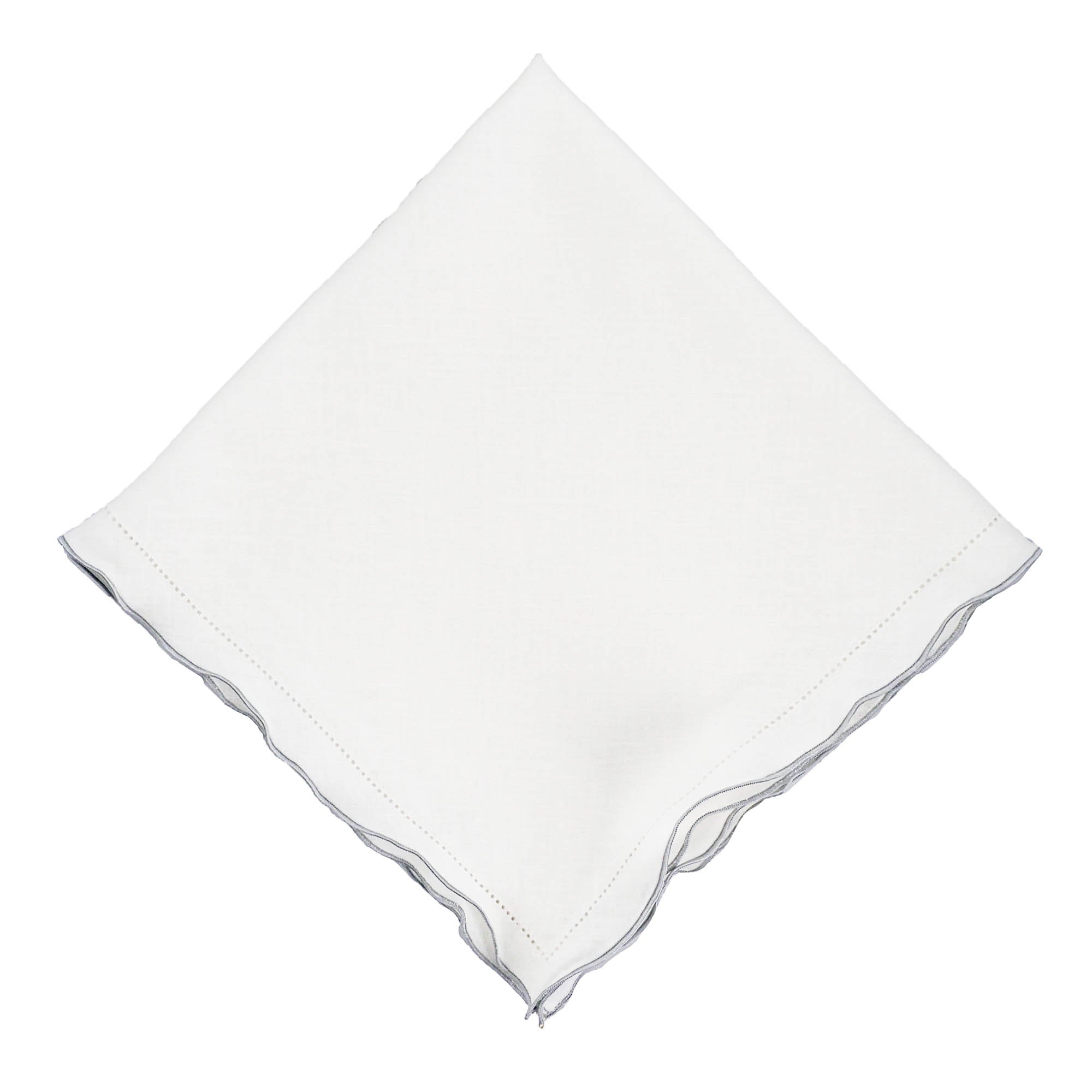 Close-up of white linen napkin featuring silver ruffled hemstitch edges, crafted from 100% high-quality linen.