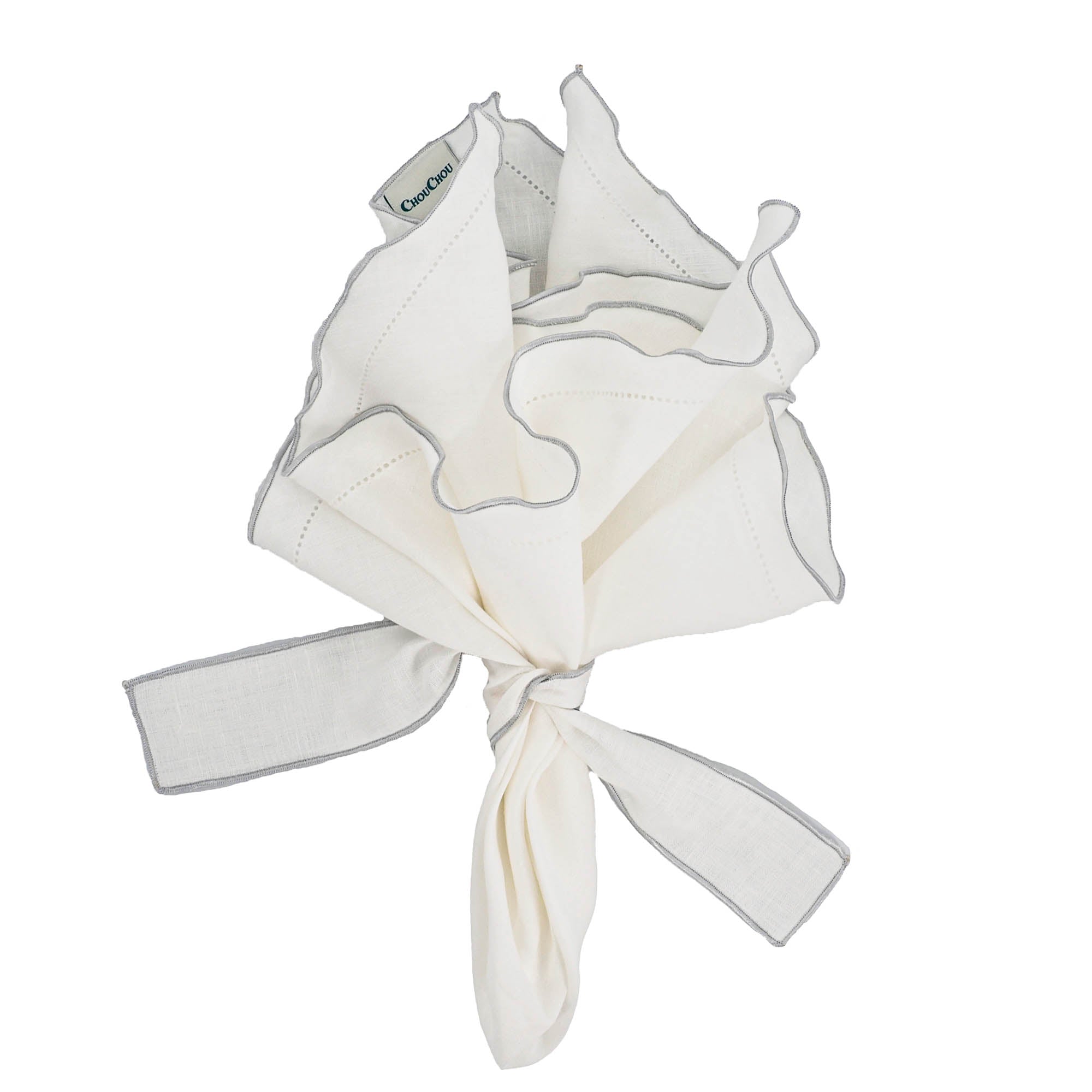 Premium white linen napkins featuring elegant silver ruffled hemstitch edges, ideal for weddings and special occasions.