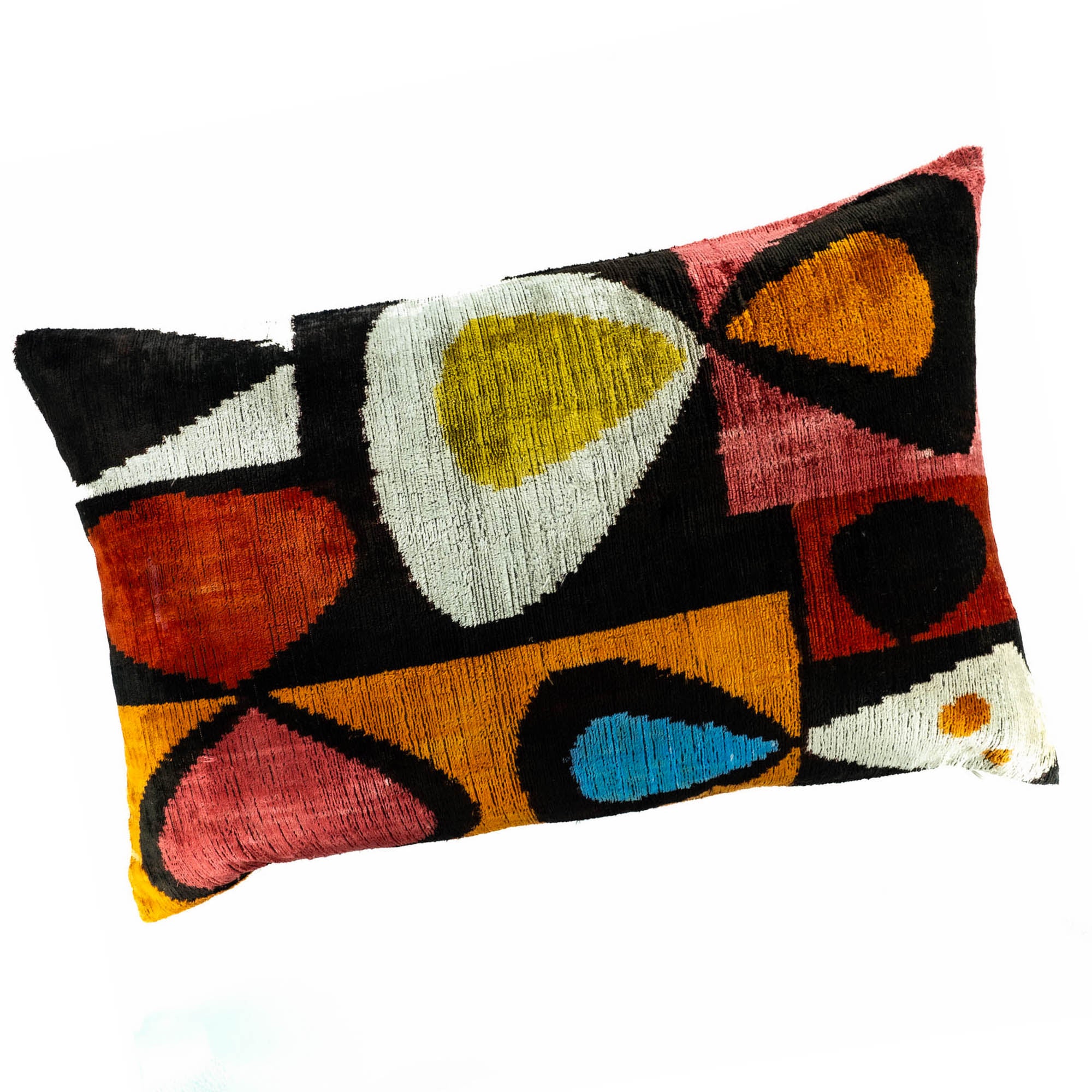 Handmade silk velvet Ikat pillow with a vibrant mix of red, yellow, blue, and orange patterns for bold and stylish home accents.
