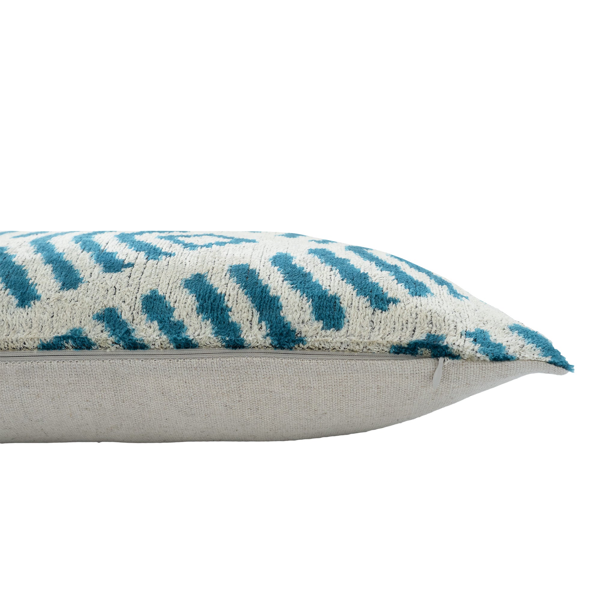 Close-up of a handmade blue silk velvet ikat pillow featuring intricate aqua blue geometric patterns, luxurious velvet texture, and artisan craftsmanship.

