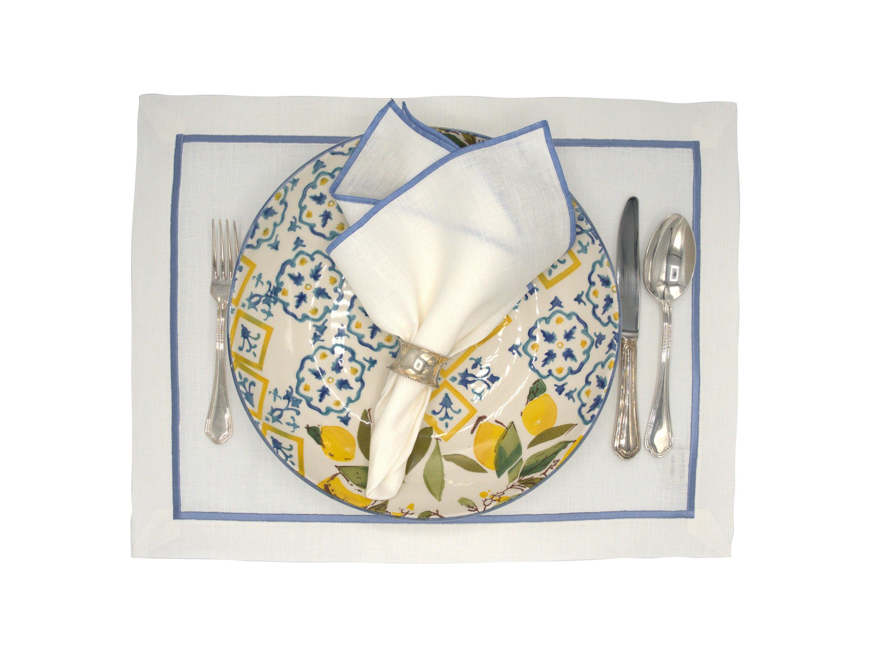 Set of 4 linen placemats with blue borders, designed for those who appreciate high-quality craftsmanship and timeless design.