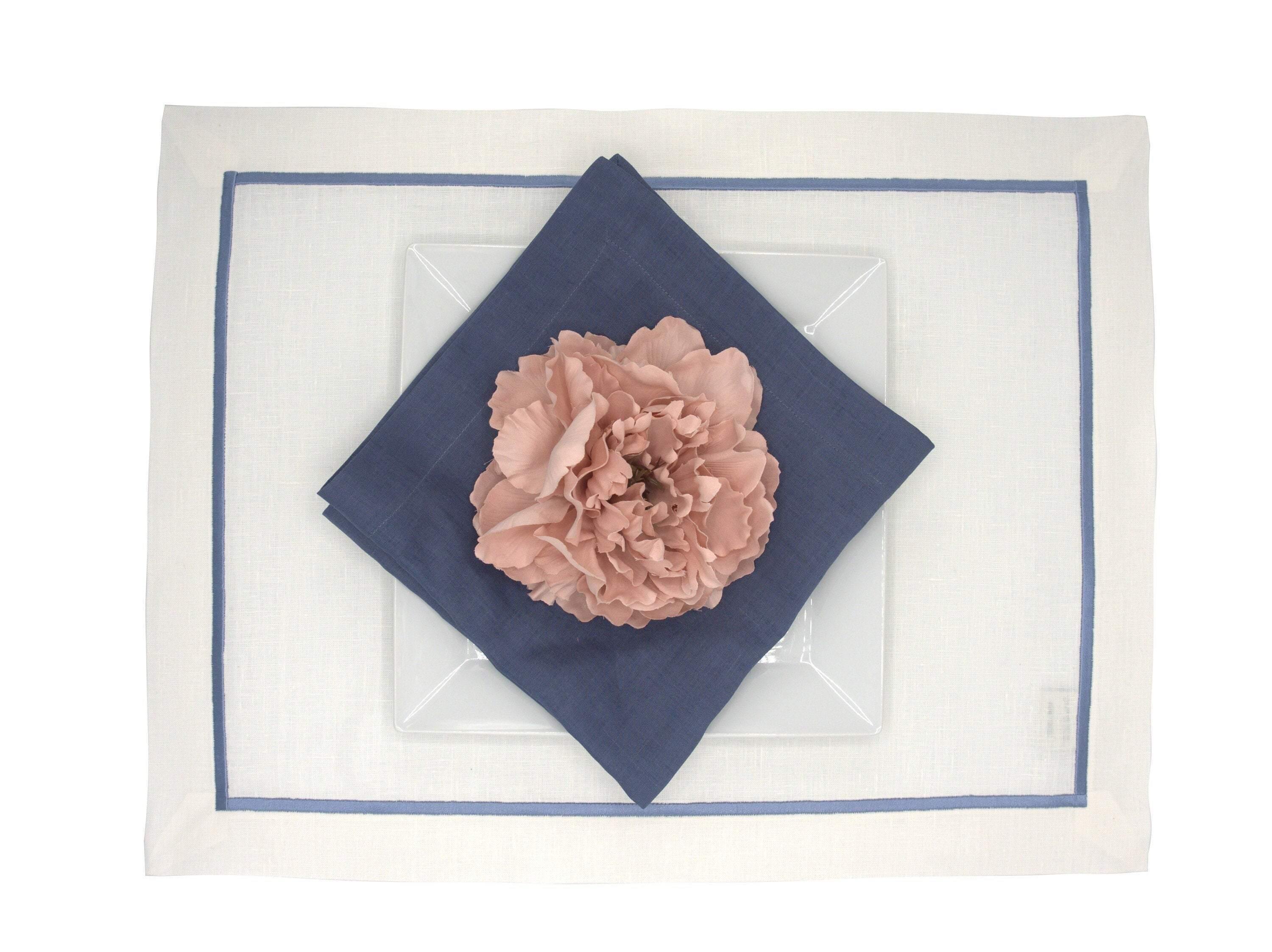 Handmade linen placemats with blue borders, offering durability and sophistication for your dining table.