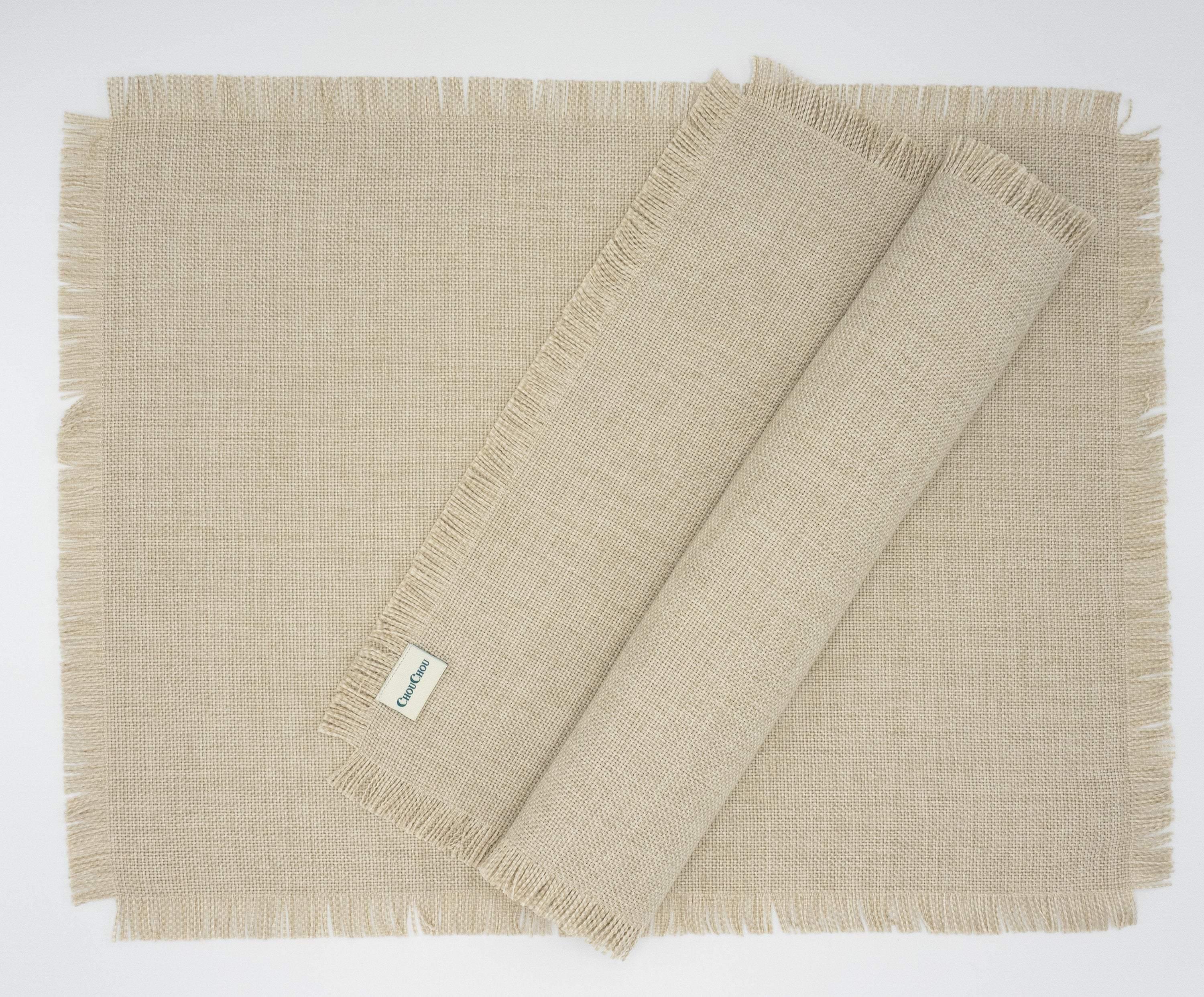 Elegant beige placemats with fringes, set of 4, made from high-quality cotton and polyester for durability and a stylish touch.