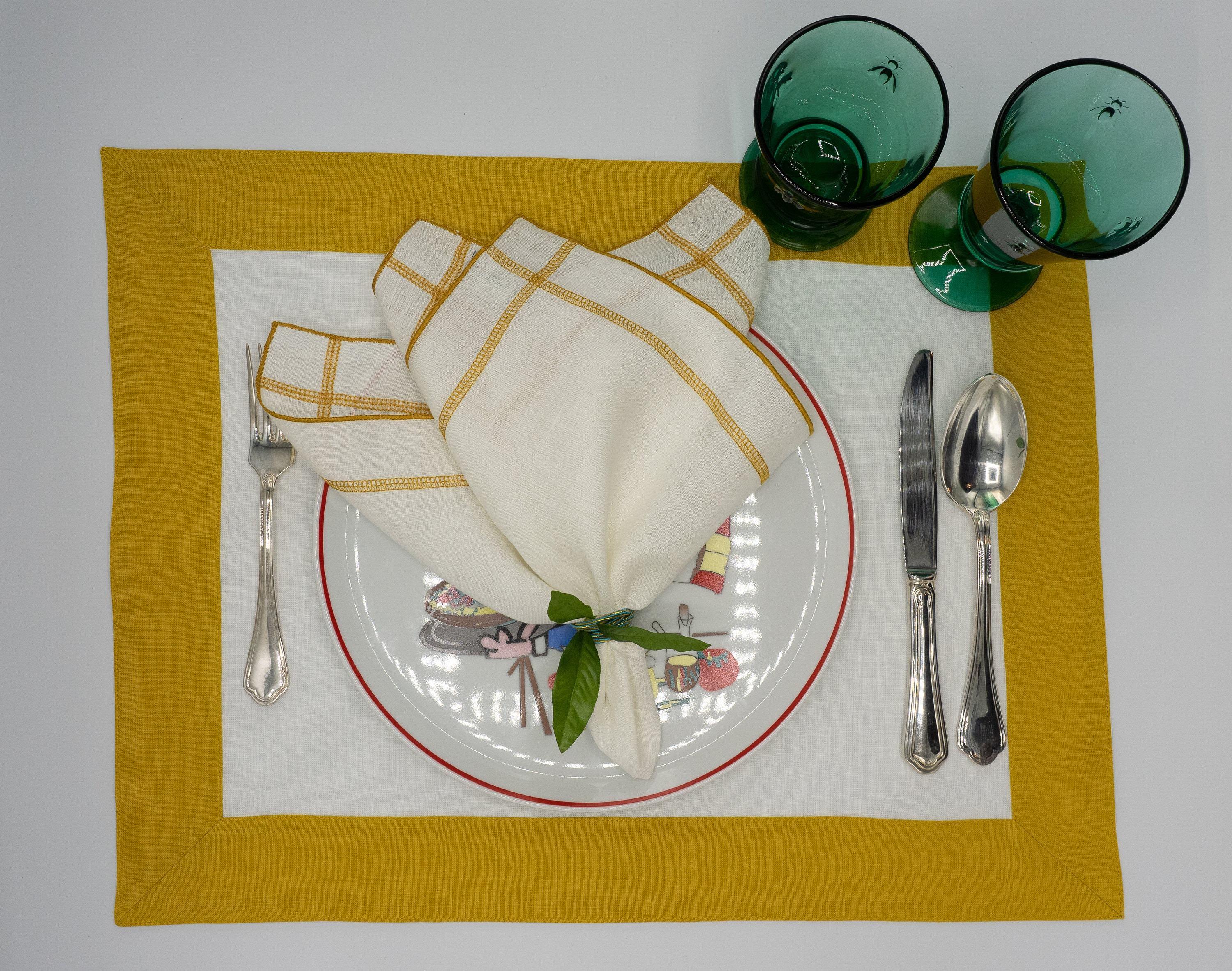 Chouchou Touch mustard-bordered linen placemats, designed to enhance your dining table with timeless sophistication.